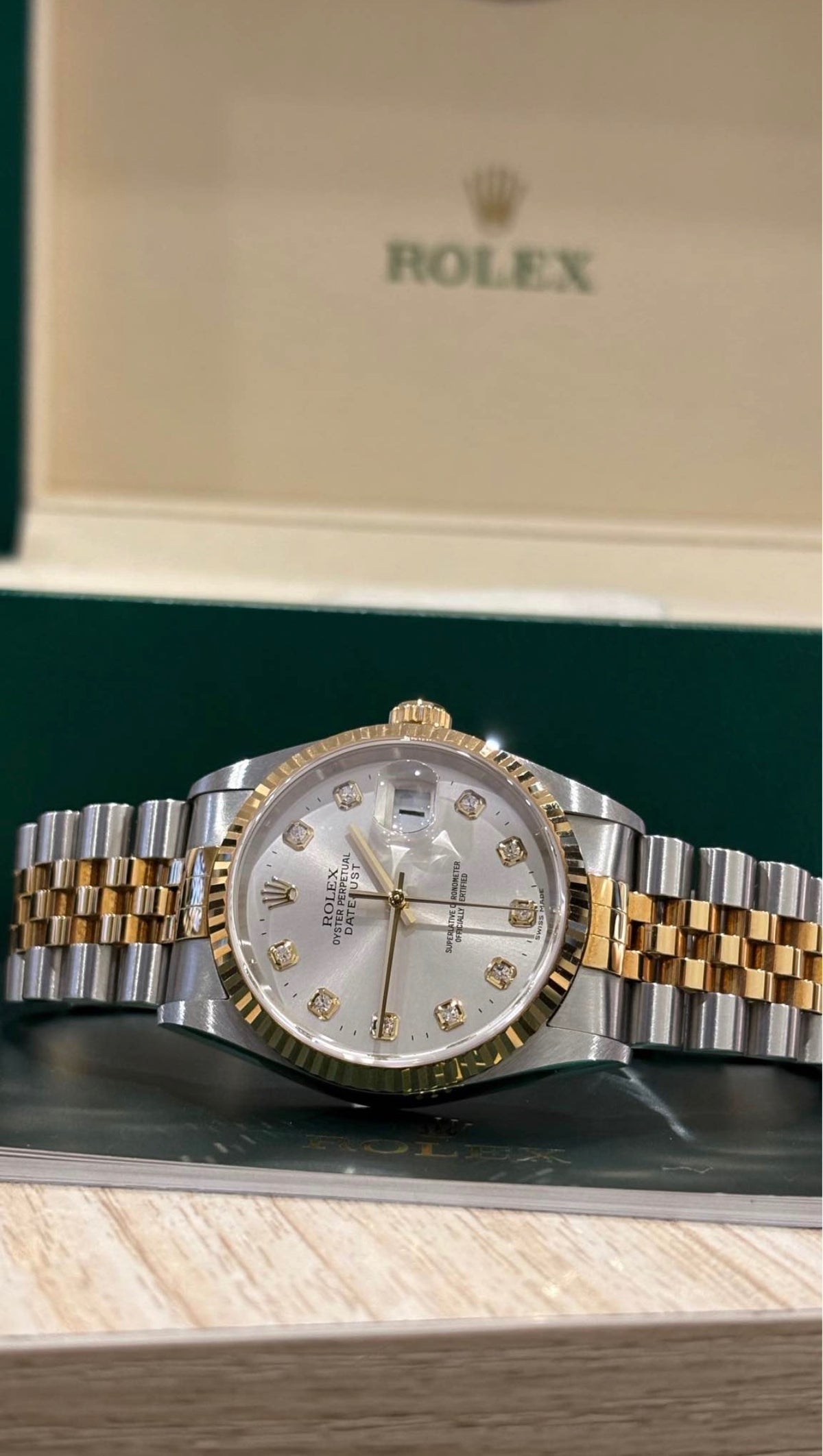 Rolex Datejust 36mm two tone silver diamond dial laid flat in front of its Rolex box