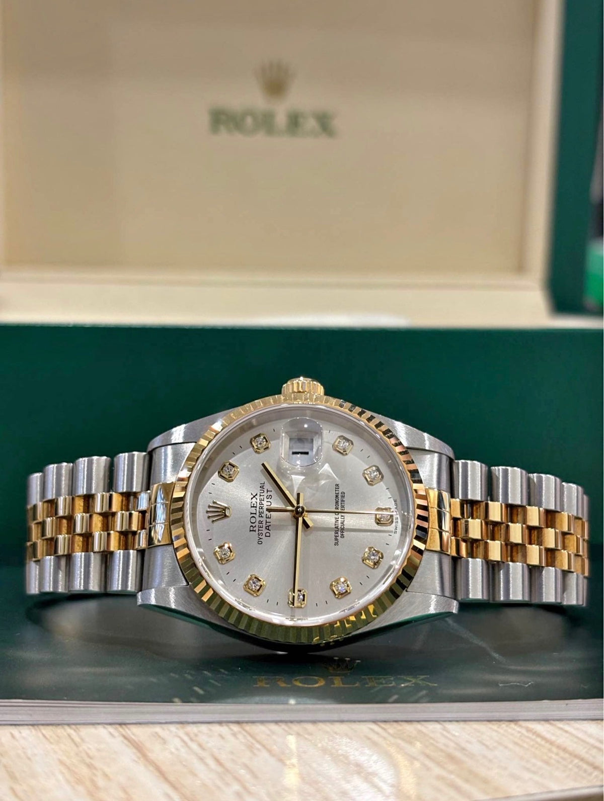 Rolex Datejust 36 silver dial with factory diamond hour markers, front view with the two tone Jubilee bracelet open