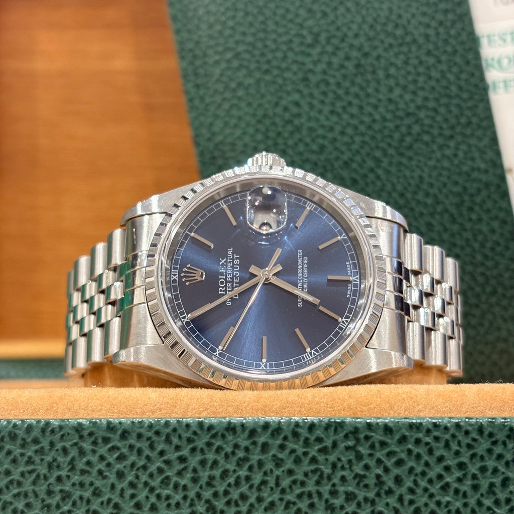 Rolex Datejust 16220 front view of the blue sunburst dial with baton index markers and Roman minute track