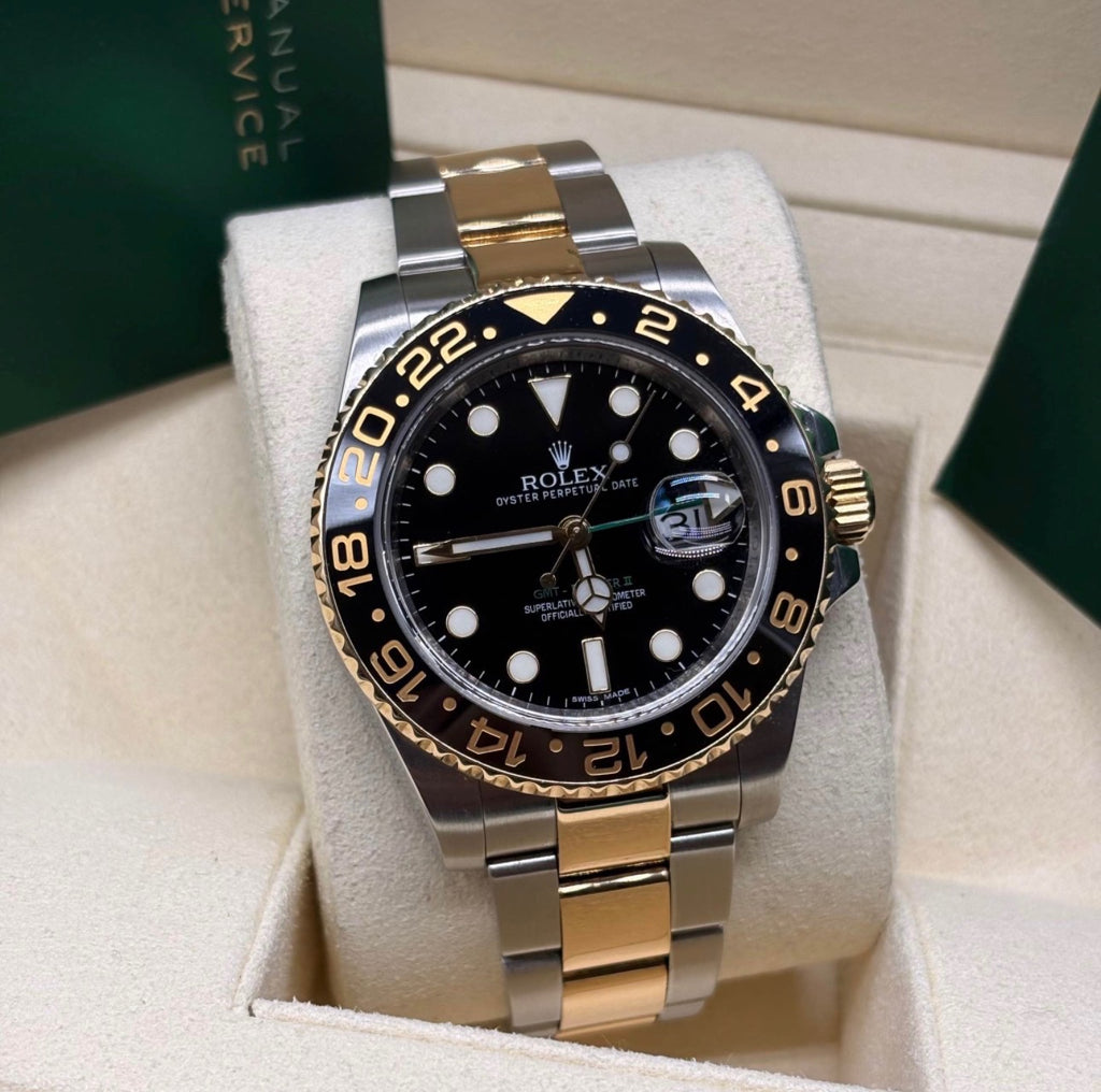 Rolex GMT Master II 116713 front view of the black dial with luminous Chromalight markers and black Cerachrom bezel on its cushion
