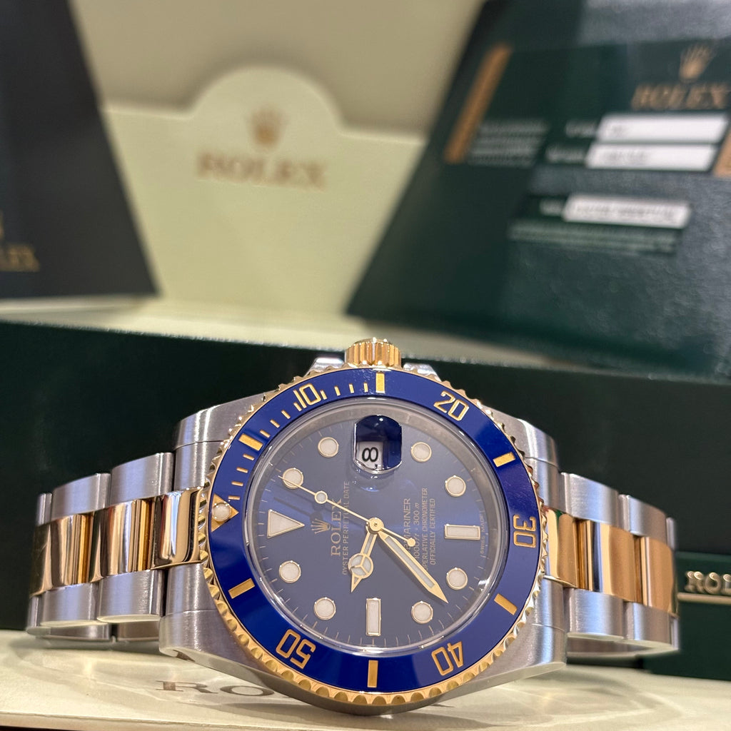 Rolex Submariner 116613LB blue dial angled view showing the yellow gold crown and bezel edge