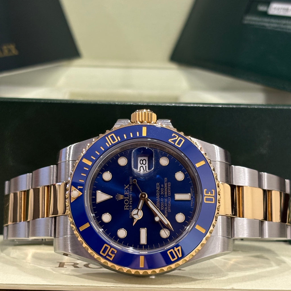 Rolex Submariner Bluesy two tone blue dial wide view with its warranty papers in the background