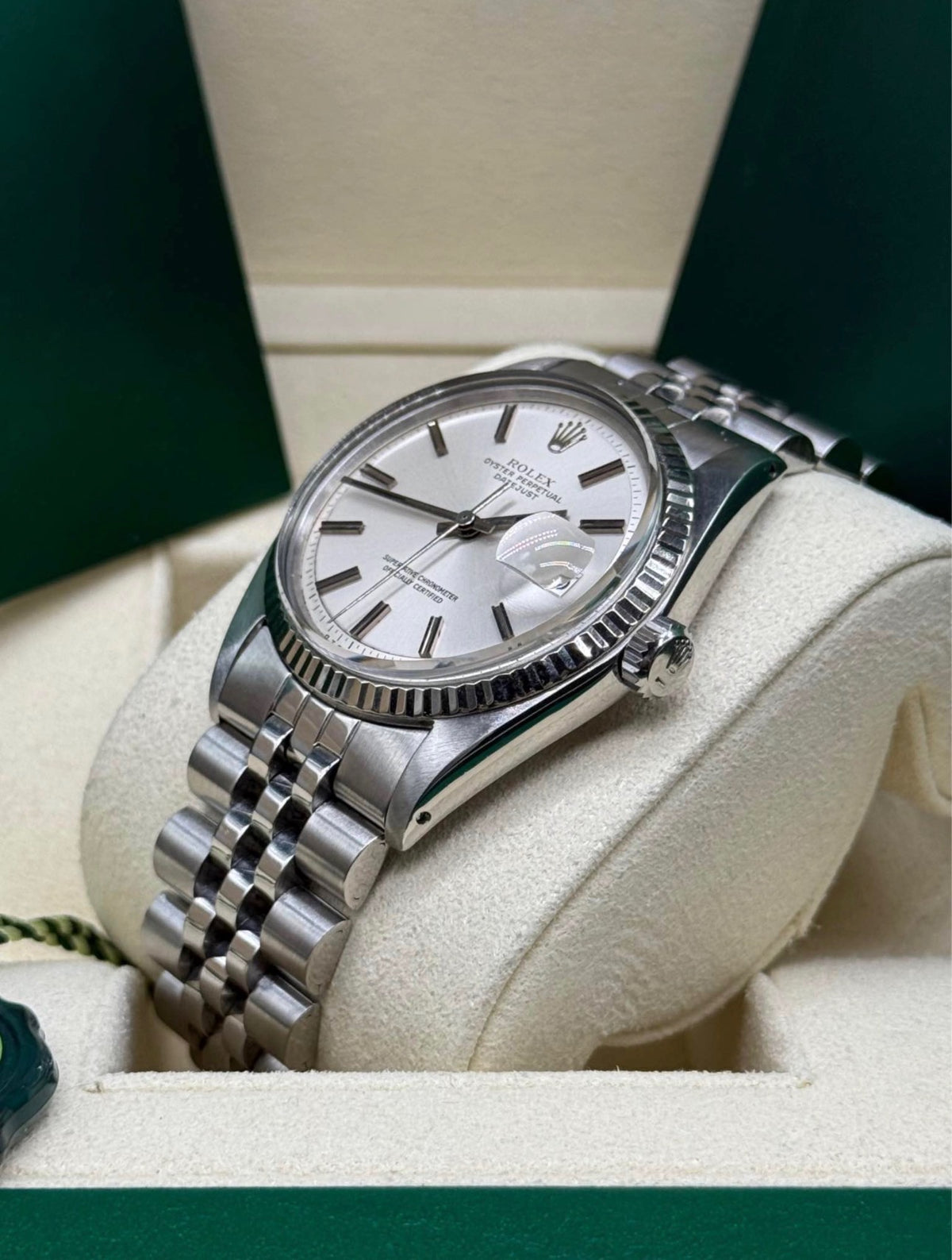 Rolex Datejust 36 16234 close angled view of the silver dial with baton index markers and white gold fluted bezel