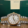 Rolex Datejust 36mm two tone silver sunray diamond dial on Jubilee bracelet with Rolex booklets behind at Adonia Jewellers in Yorkville, Toronto