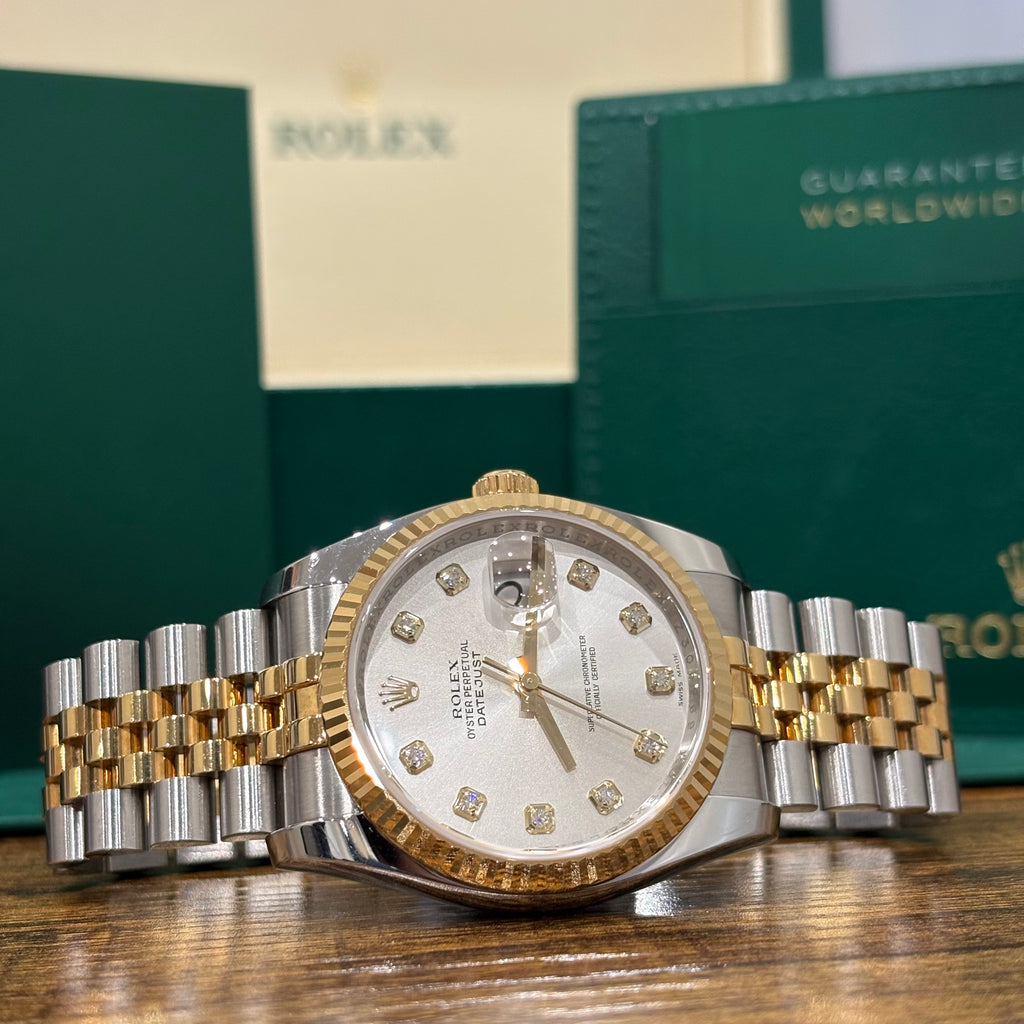 Rolex Datejust 36mm silver diamond dial angled view showing the date Cyclops and yellow gold crown