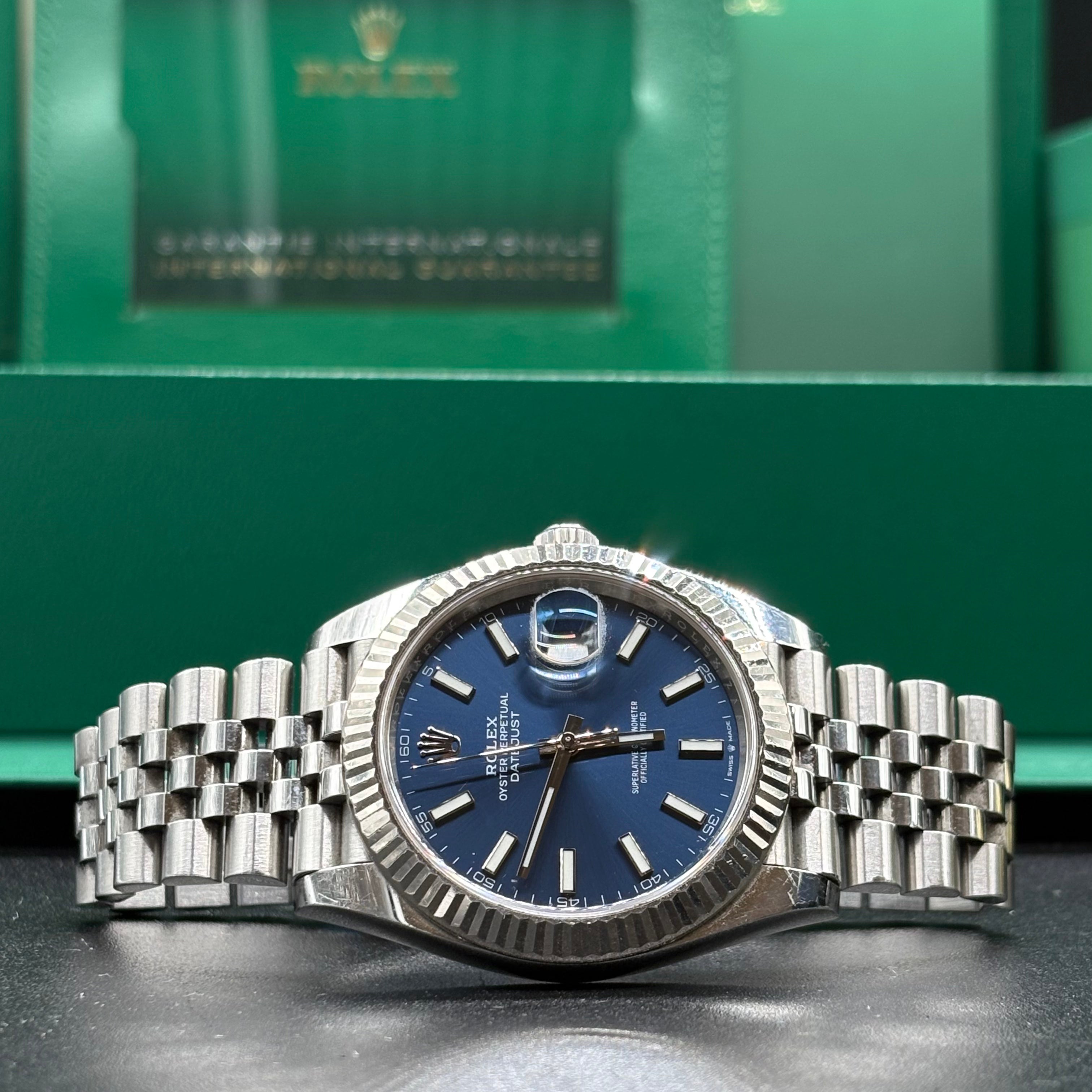 Rolex Datejust 41 blue dial close view of the polished stick markers and date Cyclops