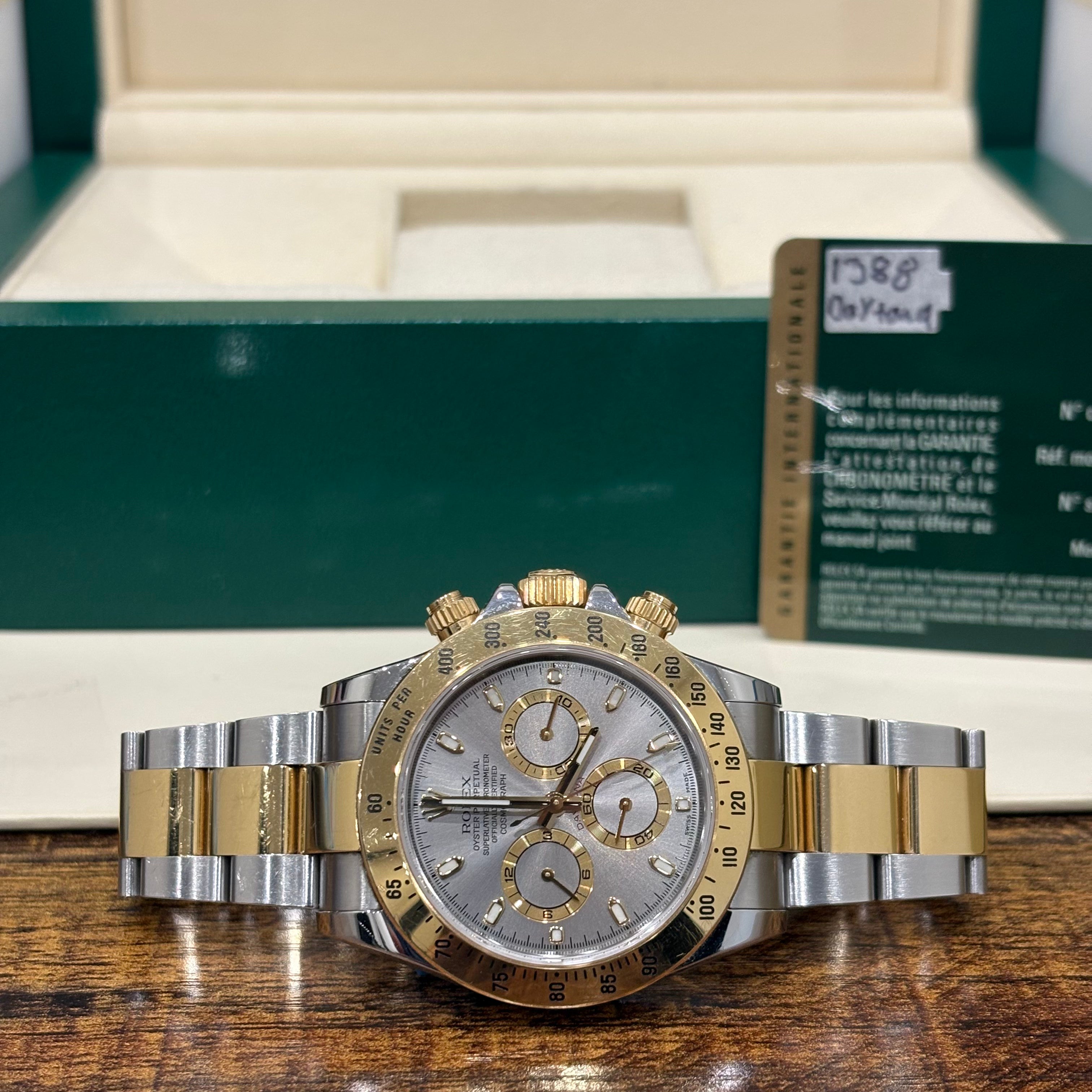Rolex Cosmograph Daytona ref 116503 two tone silver dial on Oyster bracelet with its Rolex warranty card at Adonia Jewellers in Yorkville, Toronto