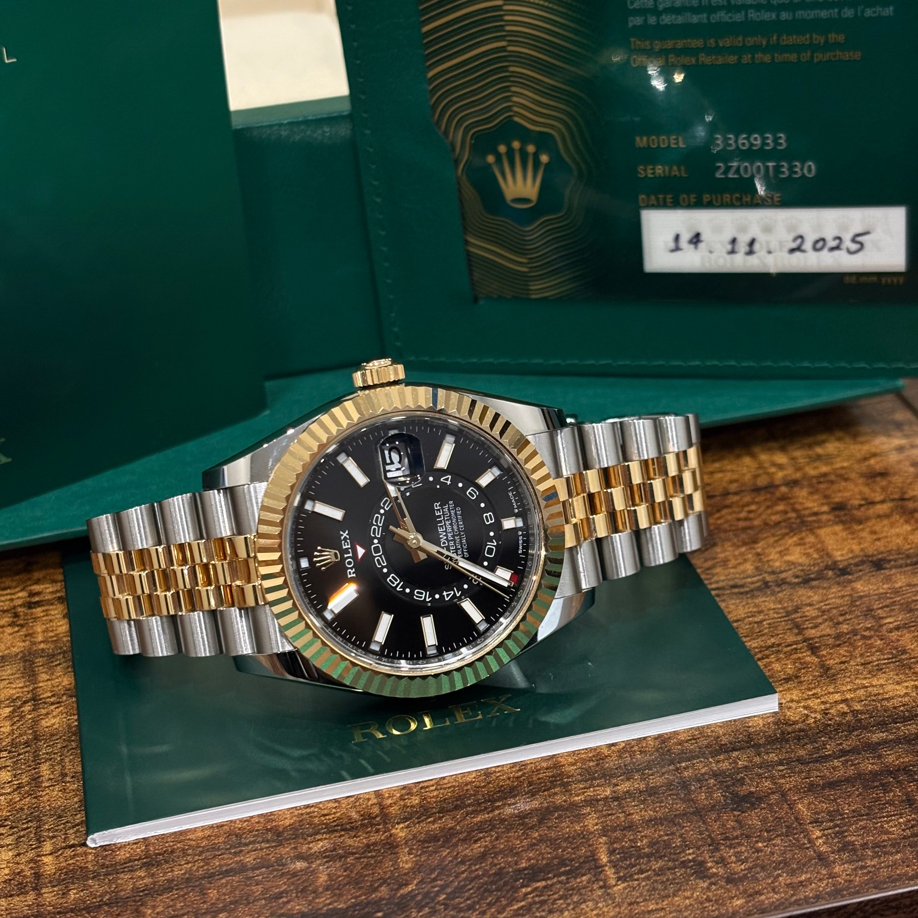 Rolex Sky Dweller 336933 two tone Jubilee laid on its booklet with the 2025 dated warranty card showing the model number