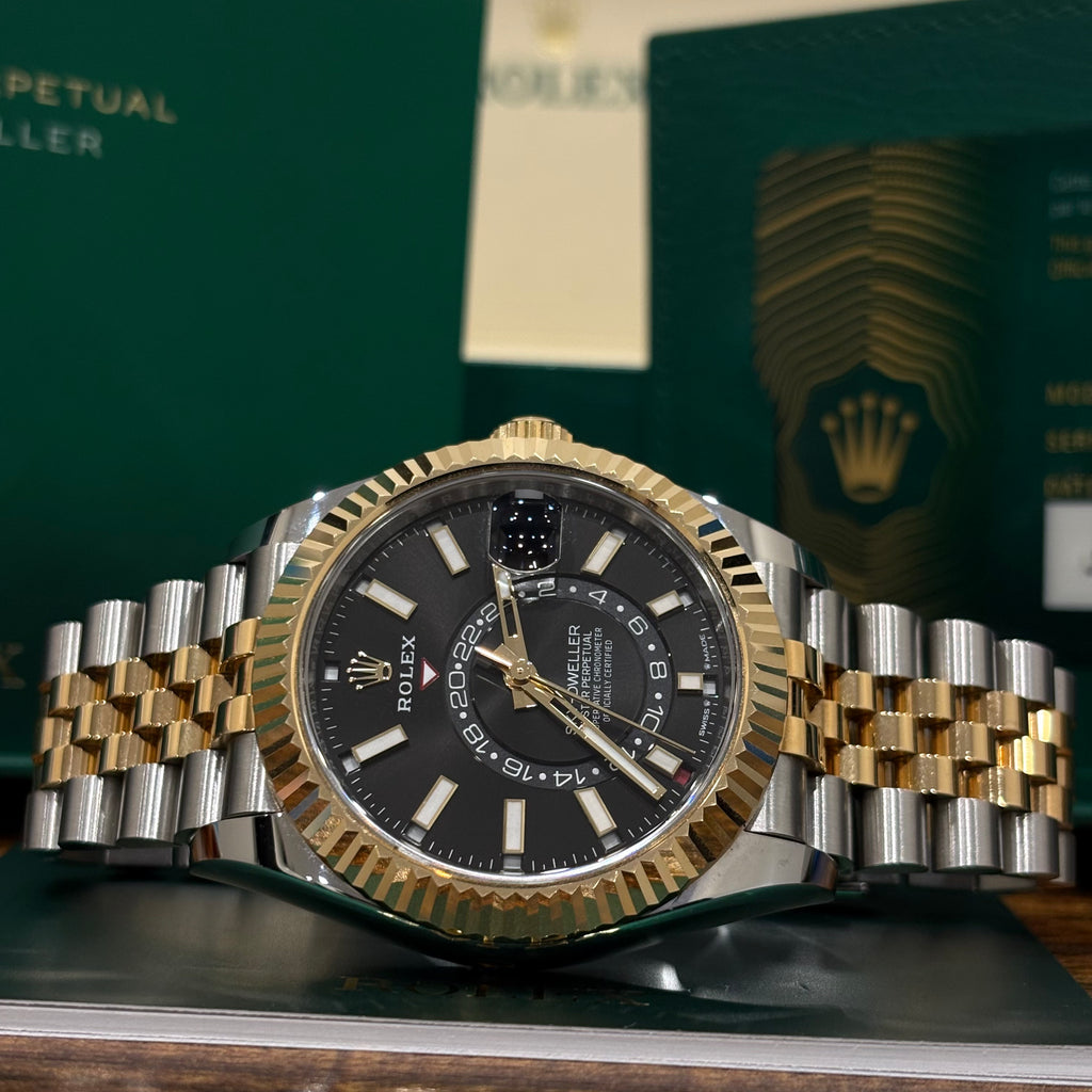 Rolex Sky Dweller 336933 black dial angled view showing the yellow gold crown