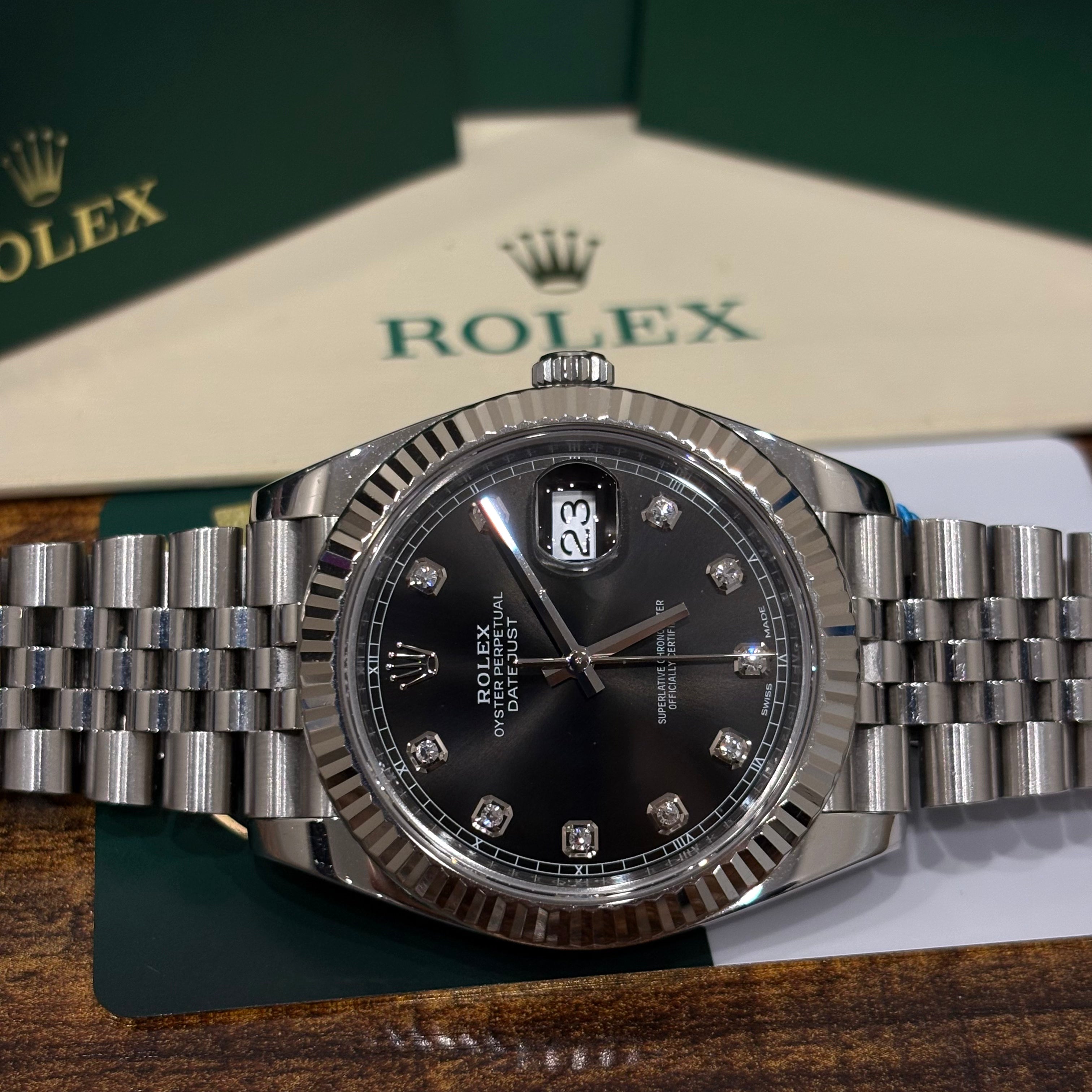 Rolex Datejust 41 126334 close view of the black dial, diamond hour markers and date Cyclops