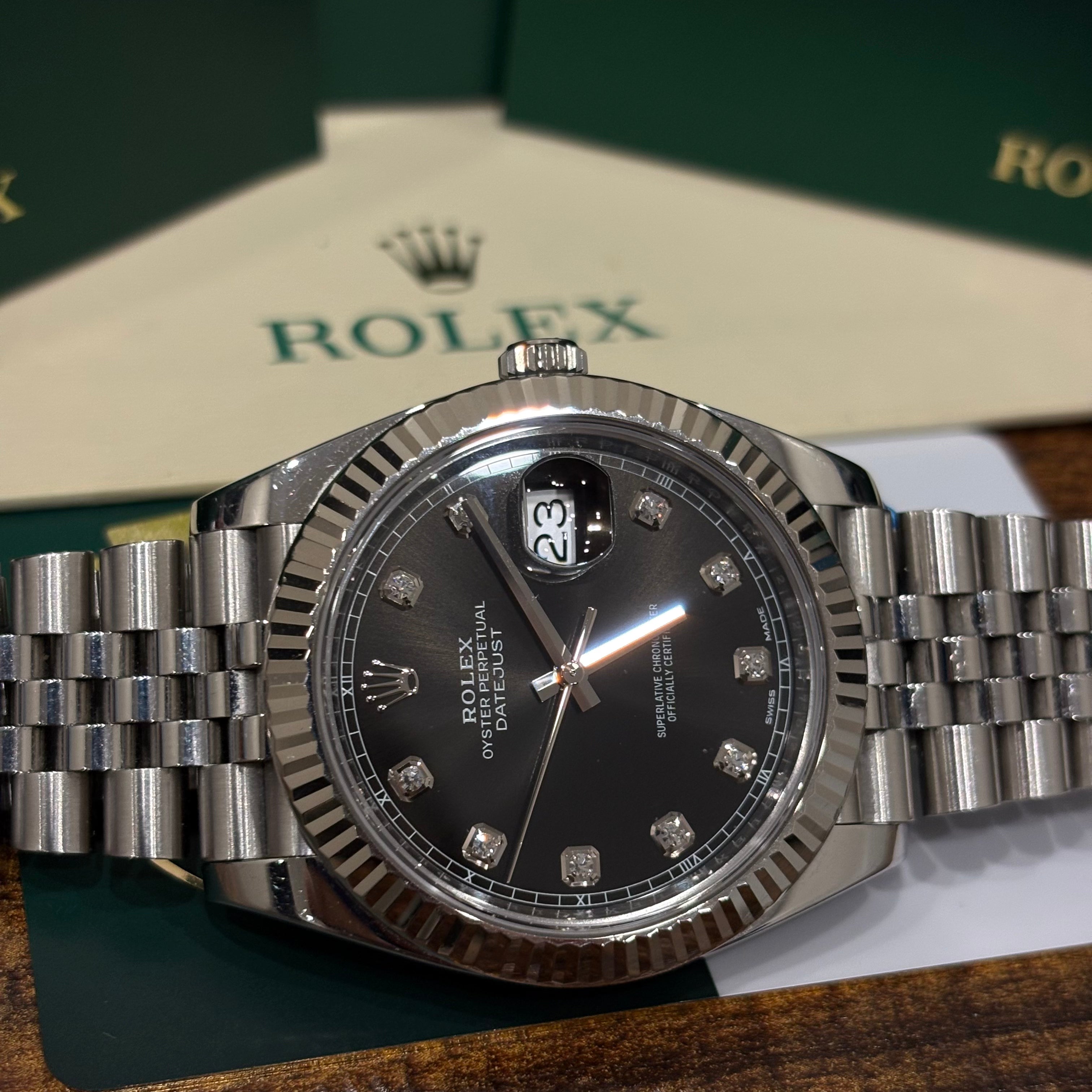 Rolex Datejust 41 126334 black diamond dial close up of the fluted bezel and winding crown