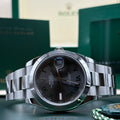 Brand new 2026 Rolex Datejust 41 ref 126300 Wimbledon slate dial with smooth bezel on Oyster bracelet, laid in front of its Rolex box at Adonia Jewellers in Yorkville, Toronto