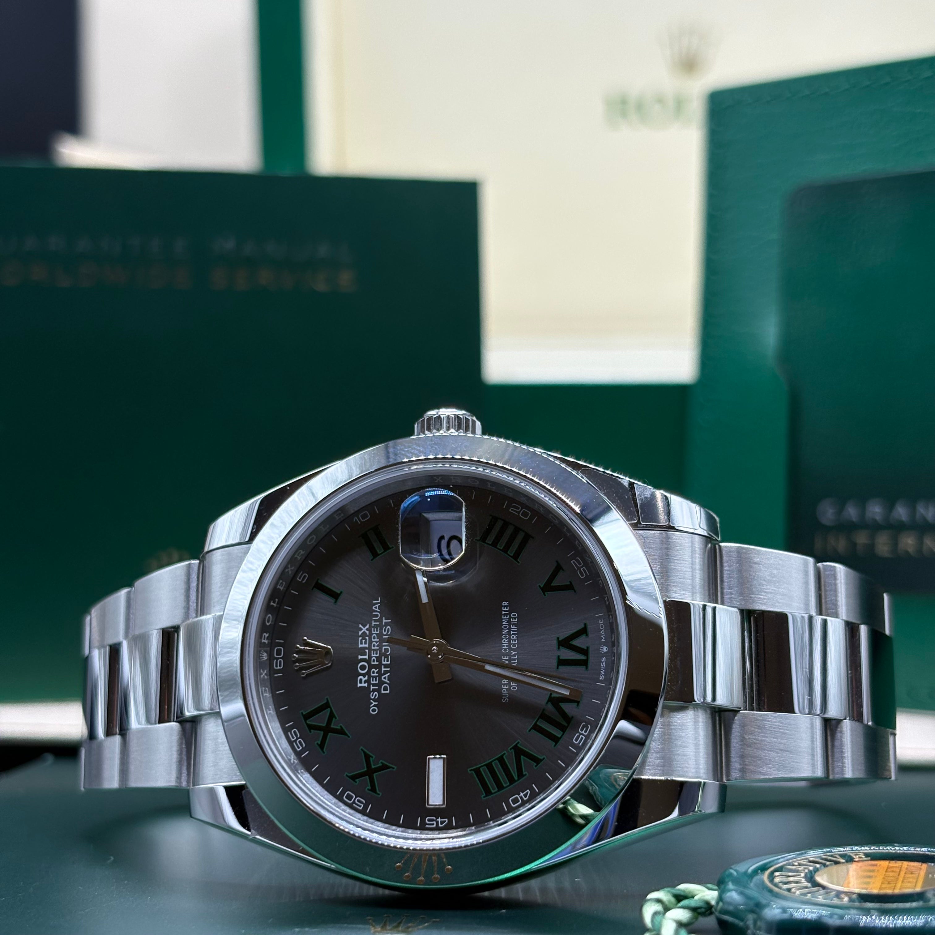 Rolex Datejust 41 126300 Wimbledon dial close view of the green outlined Roman numerals with its green hang tag