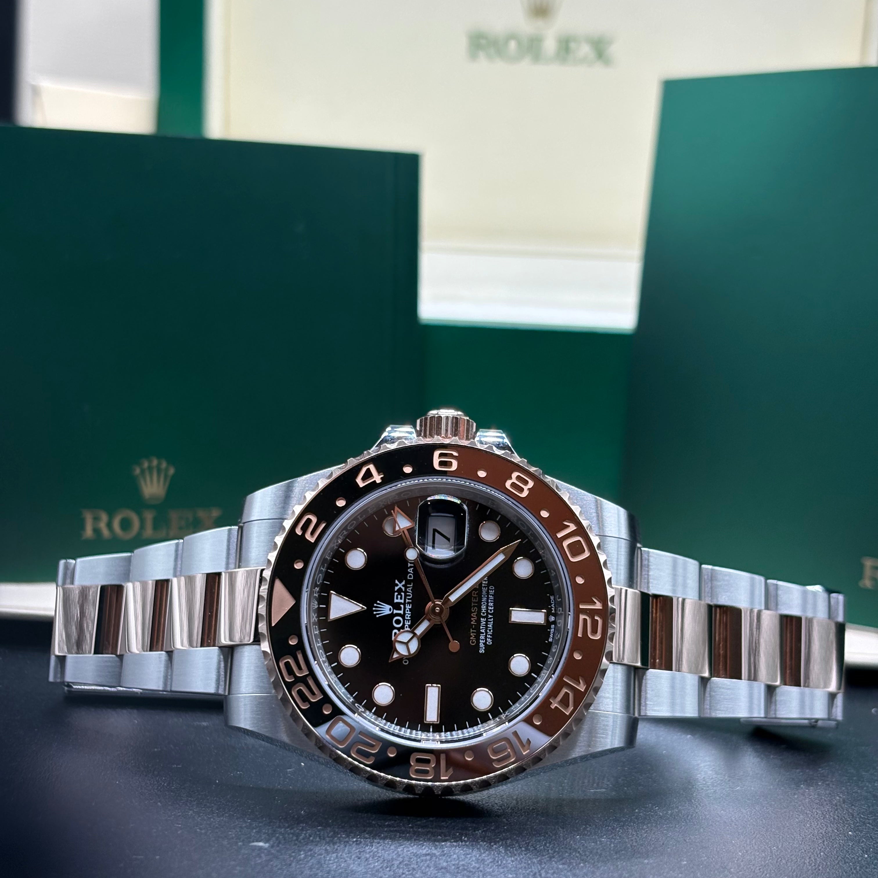 Rolex GMT Master II Root Beer 40mm two tone Oystersteel and Everose gold with brown and black Cerachrom bezel, laid flat in front of its Rolex box at Adonia Jewellers in Yorkville, Toronto
