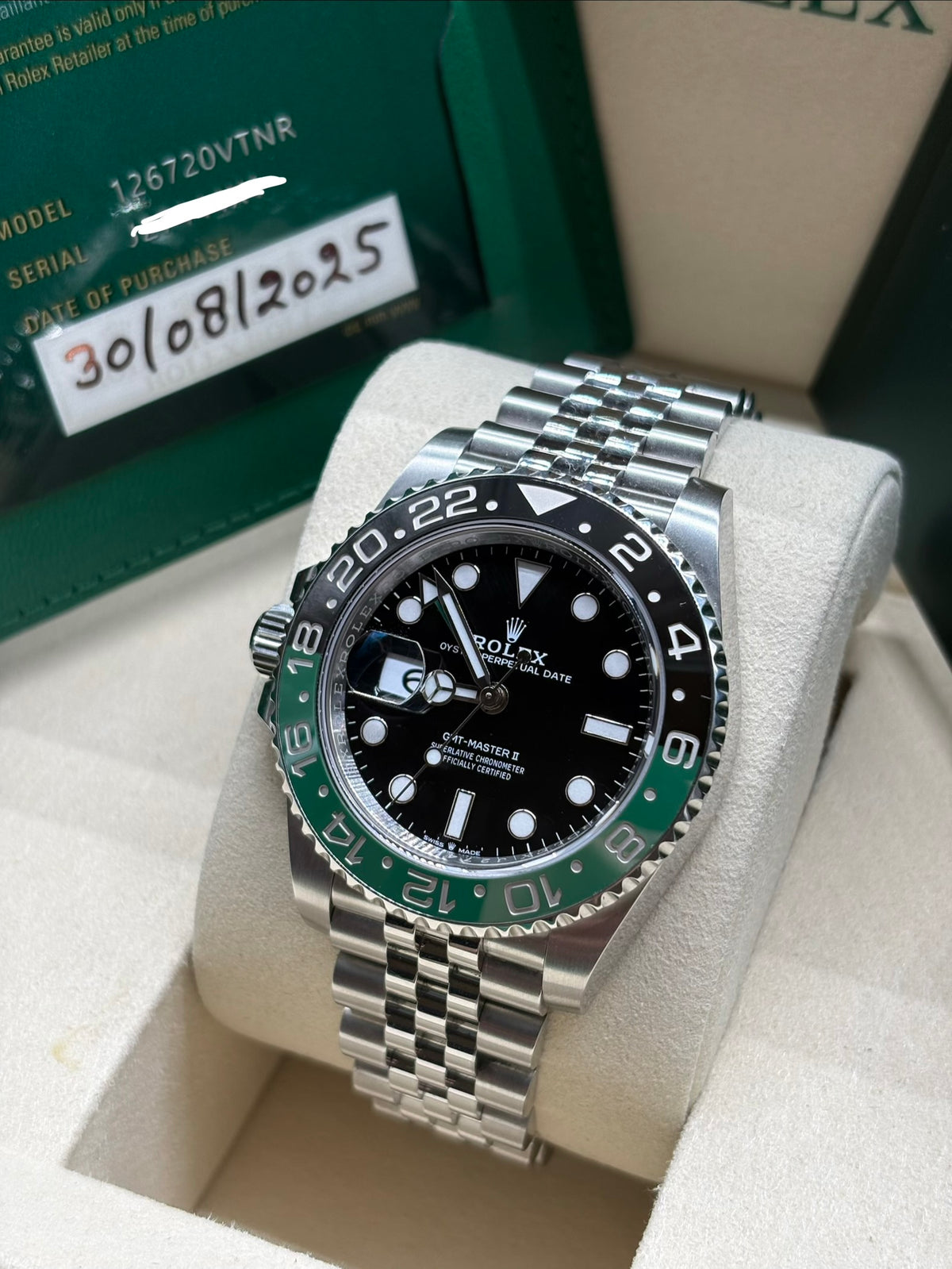 Rolex GMT Master II 126720VTNR angled view with the 2025 warranty card showing the model number