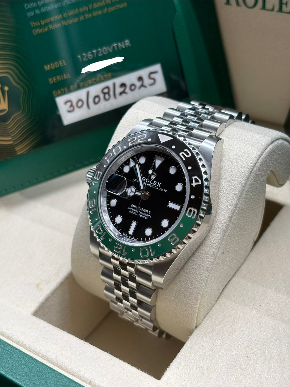 Rolex GMT Master II Sprite Jubilee angled view with dated warranty card behind