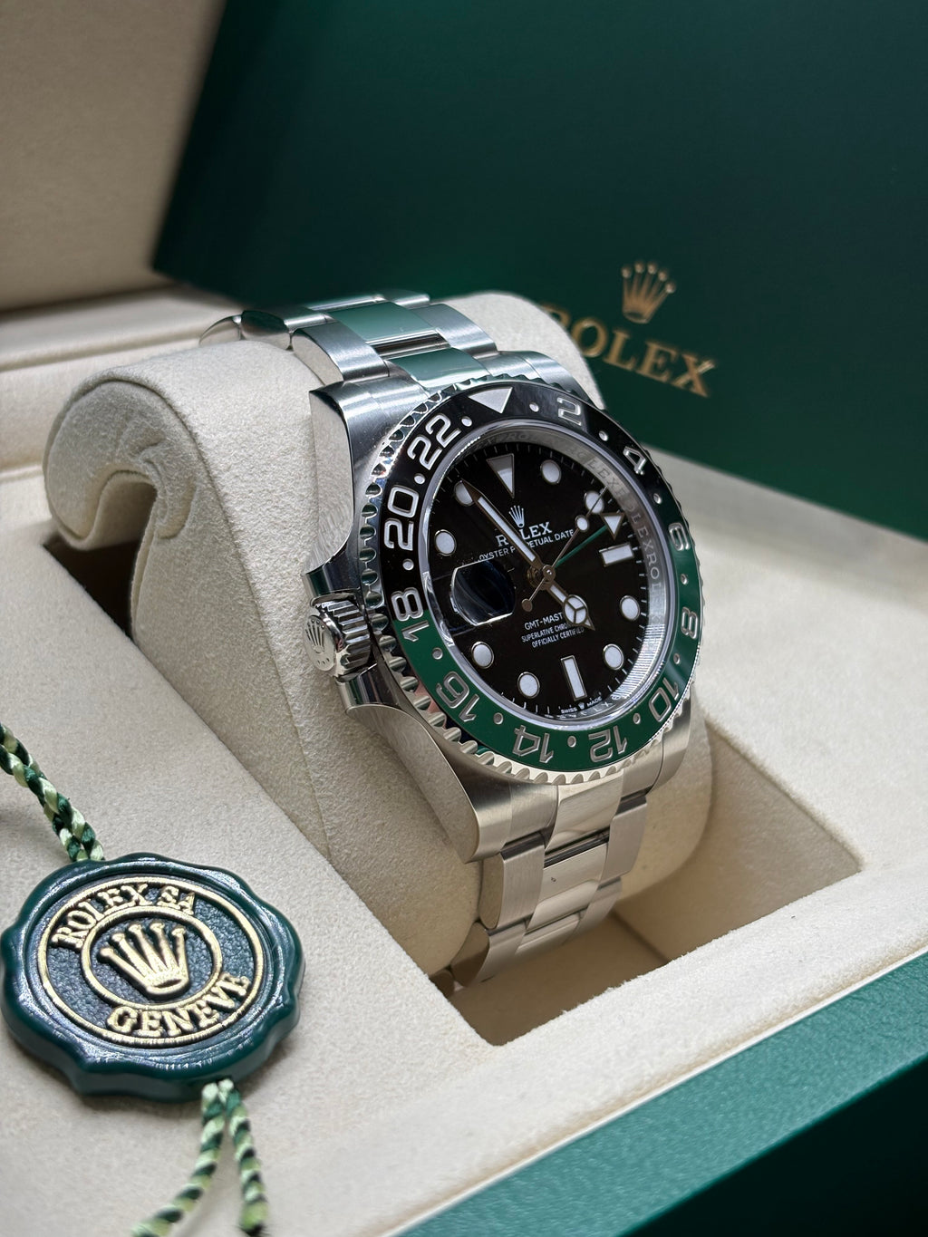 Rolex GMT Master II Sprite left hand crown side view with the green Rolex hang tag