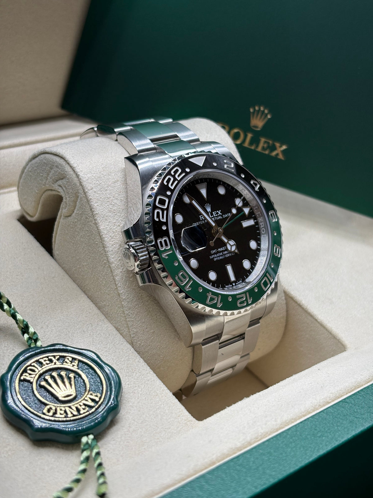 Rolex GMT Master II Sprite left hand crown side view with the green Rolex hang tag