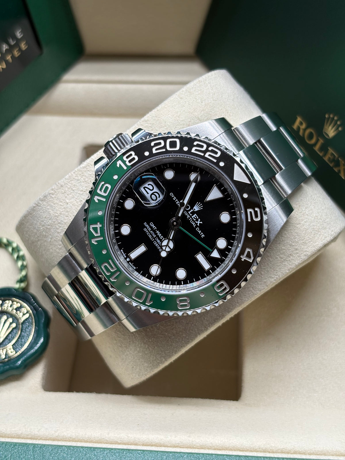 Rolex GMT Master II Sprite laid on its cushion showing the 24 hour green and black bezel