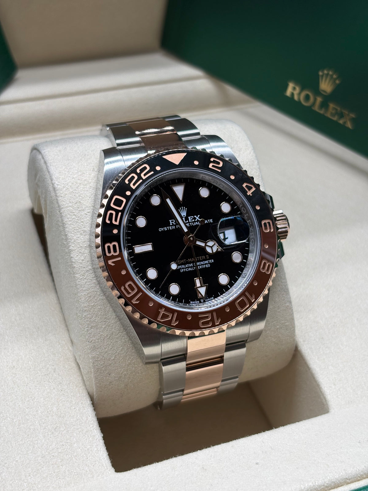 Rolex GMT Master II Root Beer front view of the black dial with rose gold GMT hand and brown and black bezel