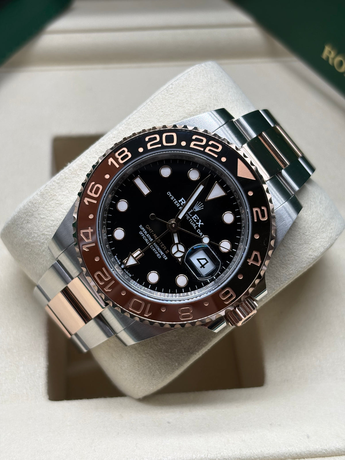 Rolex GMT Master II Root Beer laid on its cushion showing the 24 hour brown and black bezel