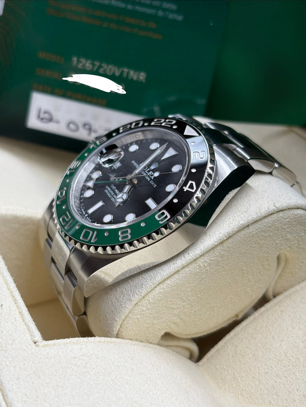 Rolex GMT Master II 126720VTNR side view with warranty card showing the model number