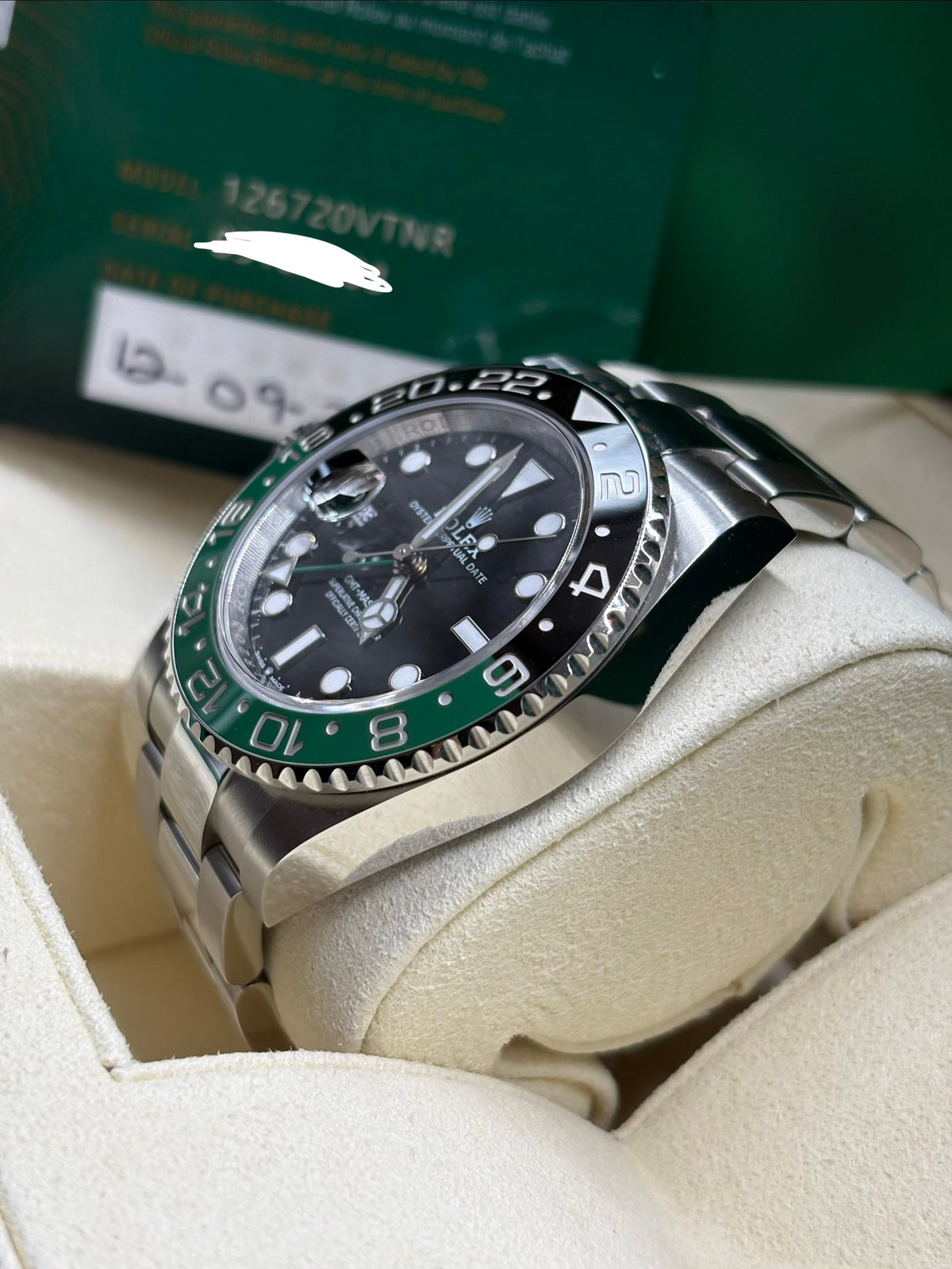 Rolex GMT Master II 126720VTNR side view with warranty card showing the model number