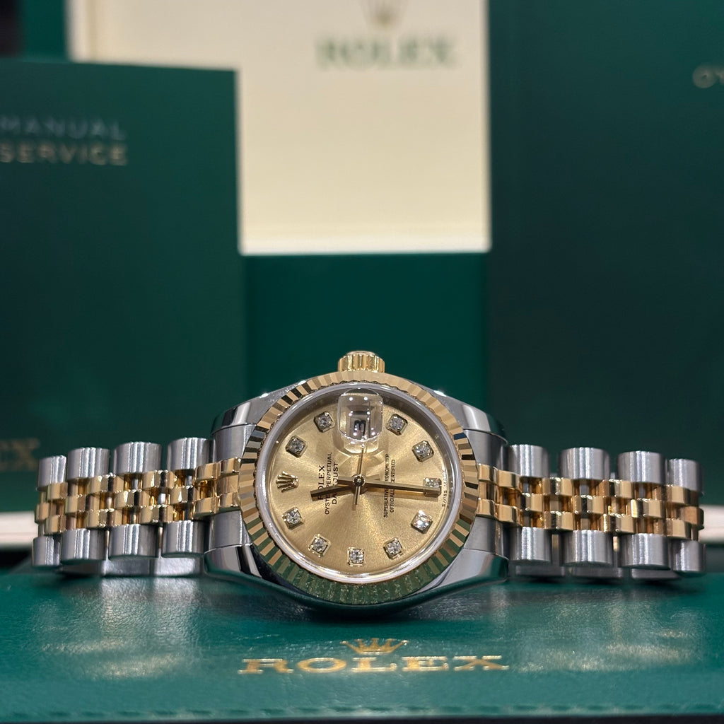 Rolex Datejust 26 ref 179173 two tone champagne diamond dial on Jubilee bracelet laid in front of its Rolex box at Adonia Jewellers in Yorkville, Toronto