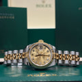Rolex Datejust 26 ref 179173 two tone champagne diamond dial on Jubilee bracelet laid in front of its Rolex box at Adonia Jewellers in Yorkville, Toronto