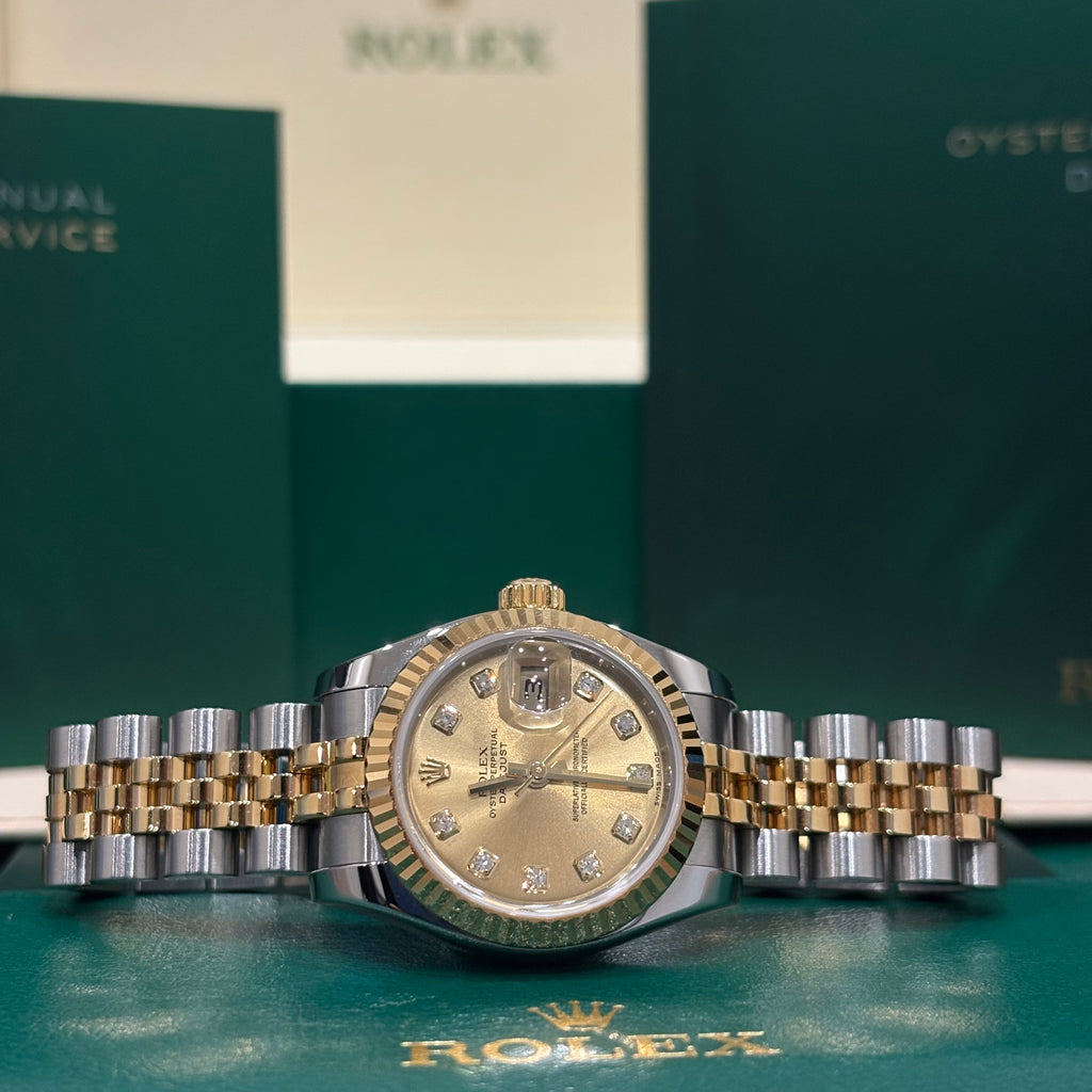 Rolex Lady Datejust 179173 champagne dial with diamond hour markers and fluted yellow gold bezel, wide view