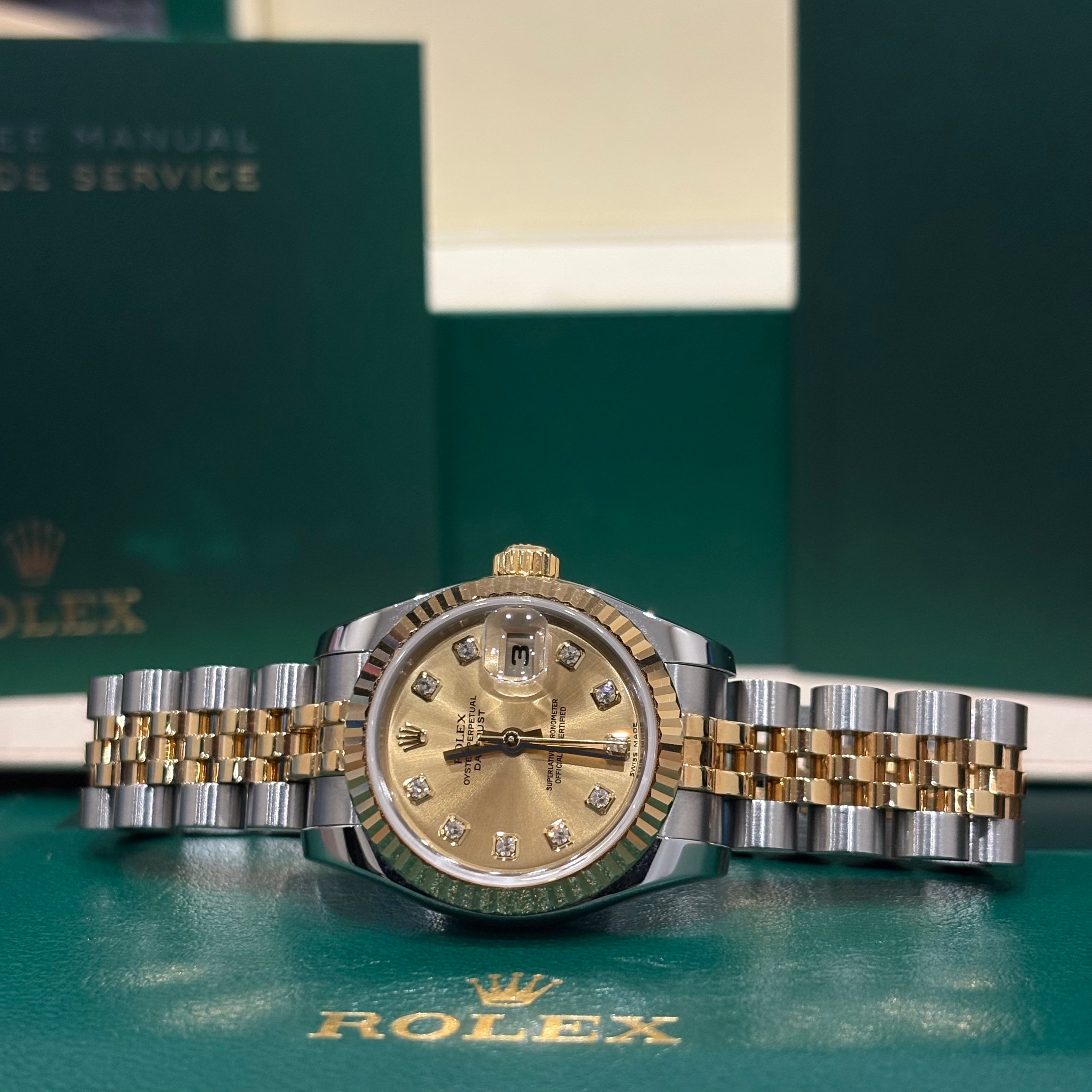 Rolex Lady Datejust 26mm two tone champagne diamond dial side on view with guarantee manual behind