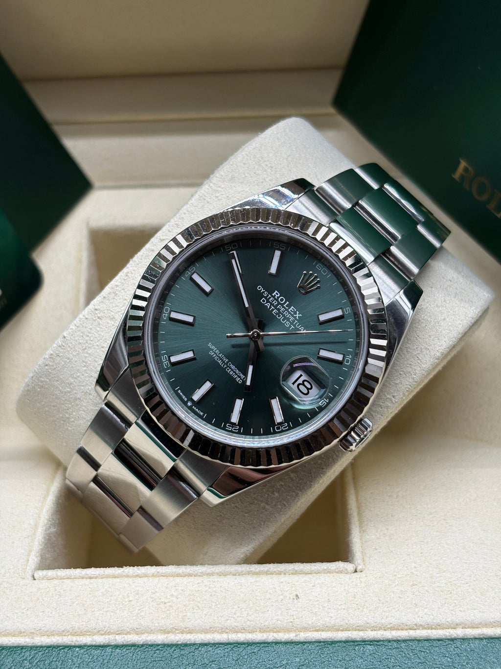 Rolex Datejust 41 mint green dial on Oyster bracelet, angled view on its cushion in the Rolex box