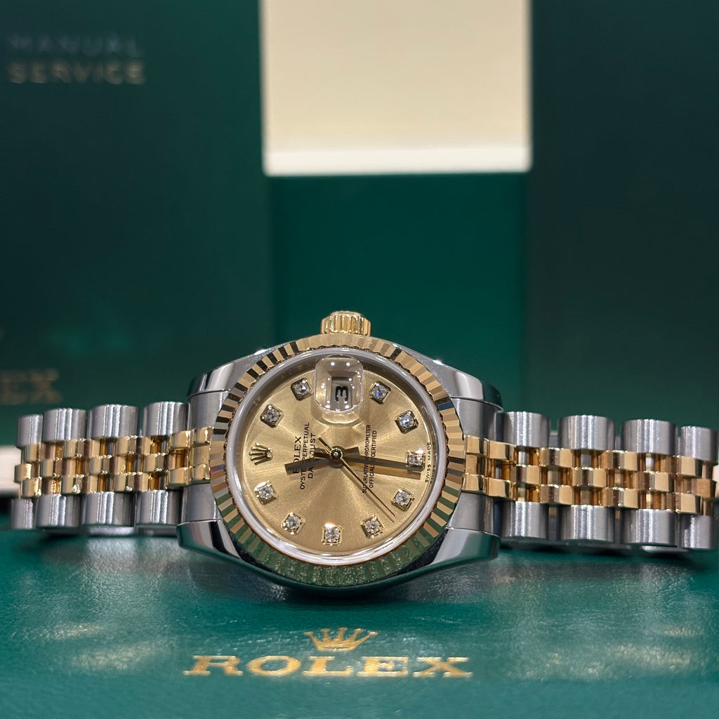 Rolex Datejust 26 179173 champagne dial close up showing the yellow gold crown and Jubilee links