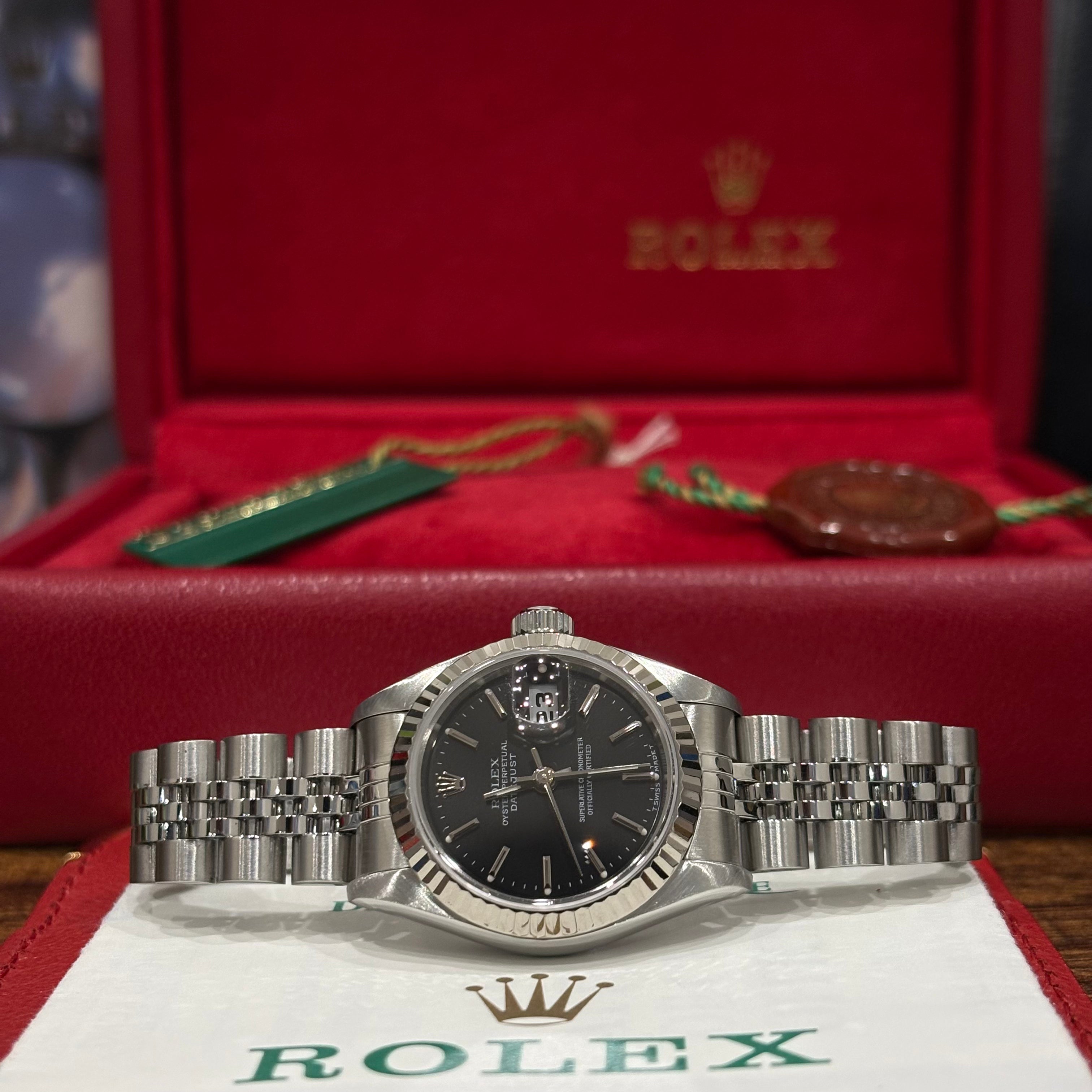 Rolex Datejust 26 ref 69174 black stick dial with white gold fluted bezel on Jubilee bracelet, full set with its red Rolex box at Adonia Jewellers in Yorkville, Toronto