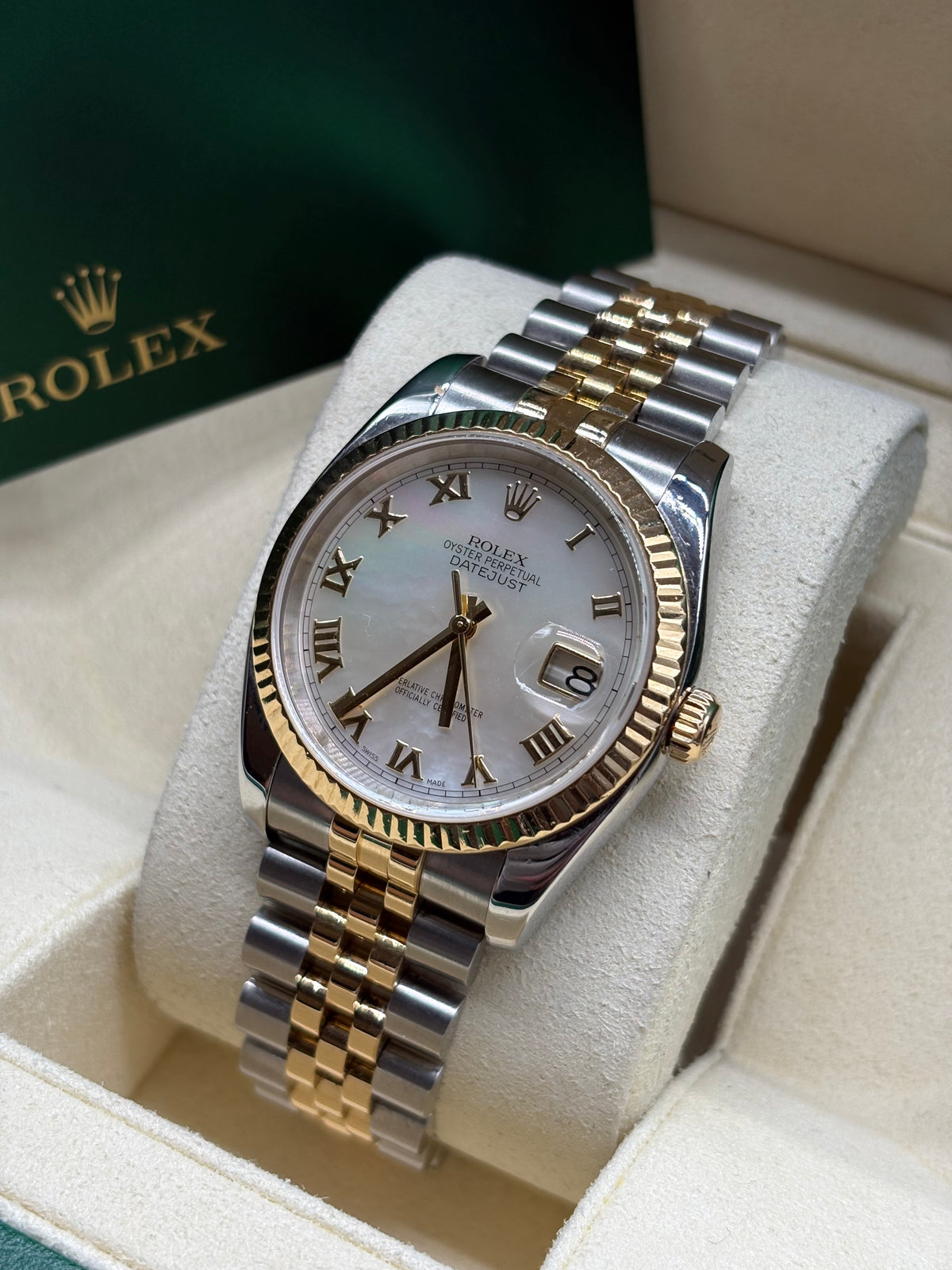 Rolex Datejust 36mm two tone mother of pearl dial showing the date window and yellow gold crown