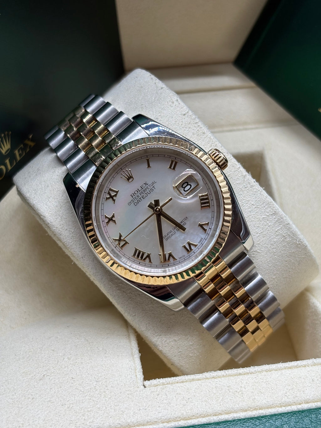 Rolex Datejust 116233 mother of pearl Roman dial close angled view of the fluted 18K yellow gold bezel