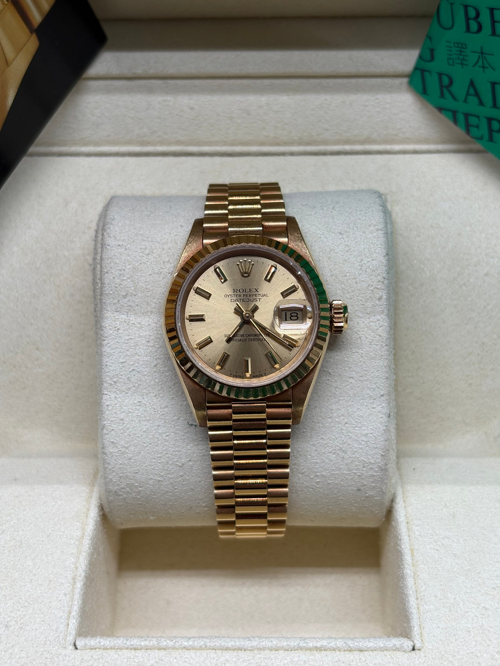 Rolex Lady Datejust 26 front view of the champagne dial with yellow gold baton index markers and fluted bezel