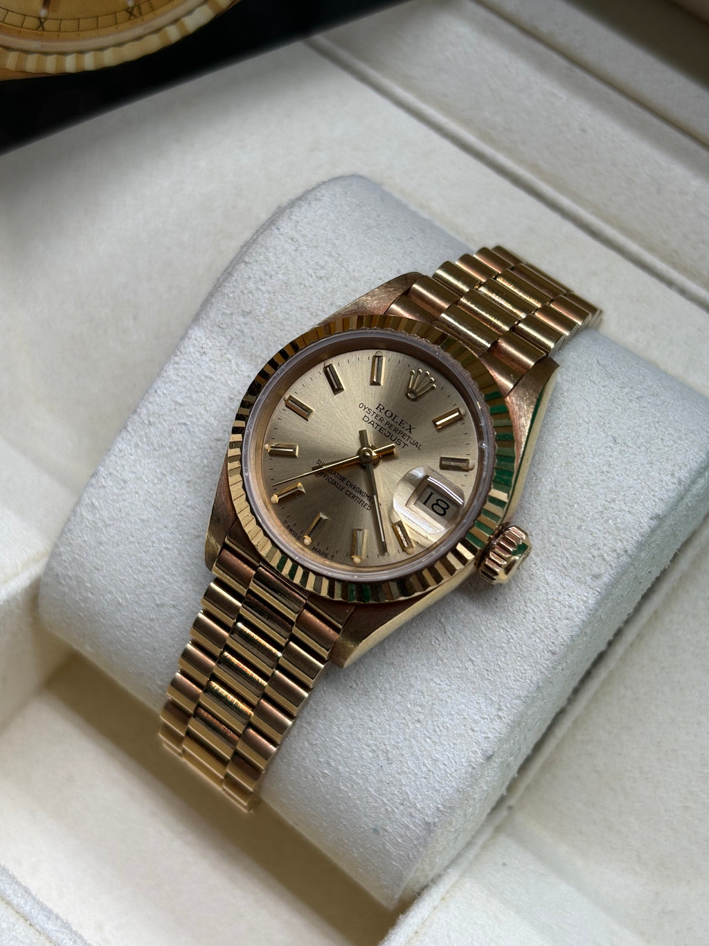 Rolex Lady Datejust 26mm yellow gold champagne dial laid on its cushion in the Rolex box