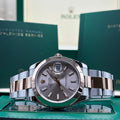 Rolex Datejust 41mm two tone Everose gold sundust dial with smooth bezel on Oyster bracelet, laid on its guarantee wallet at Adonia Jewellers in Yorkville, Toronto