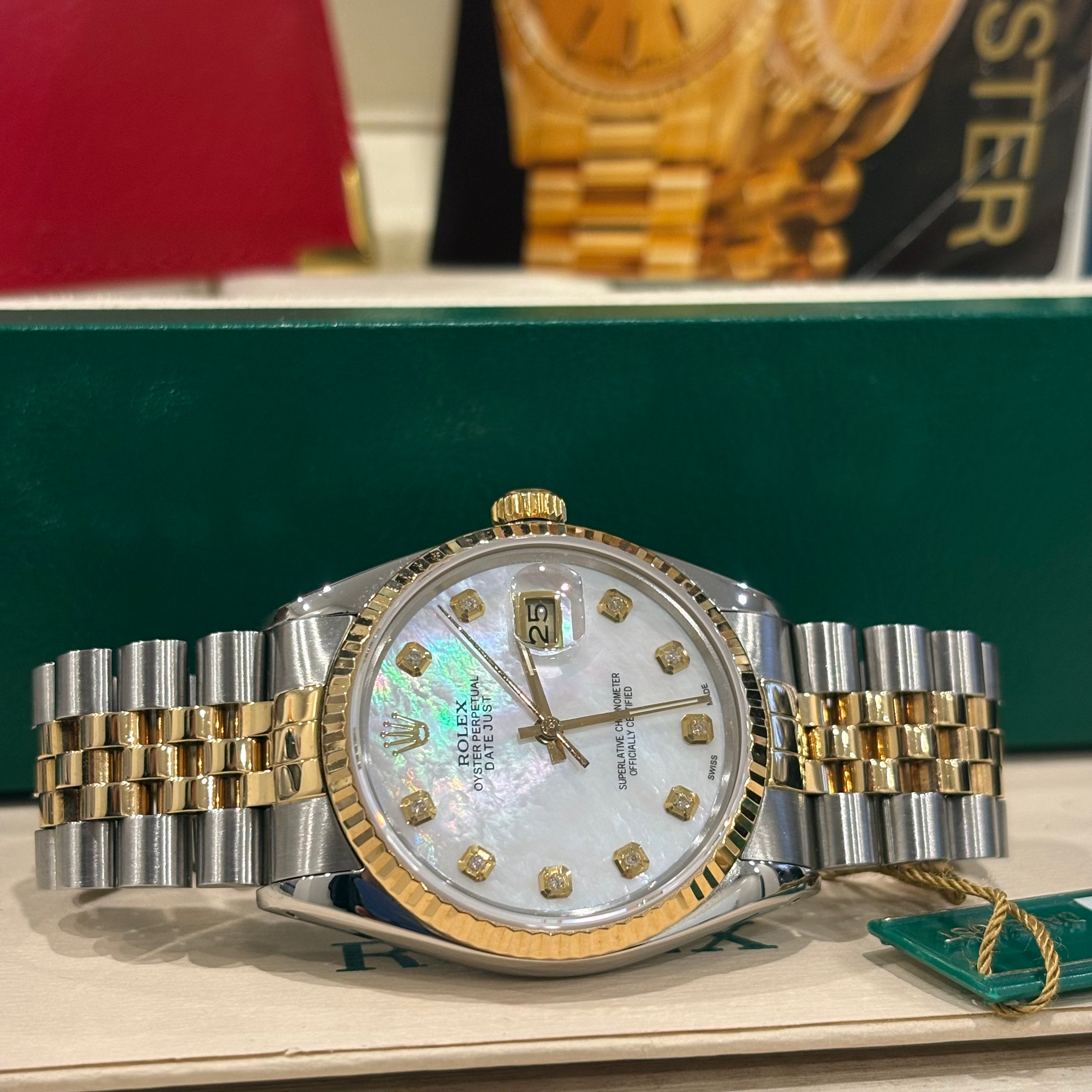 Rolex Datejust 16013 close view of the mother of pearl dial, fluted yellow gold bezel and date Cyclops