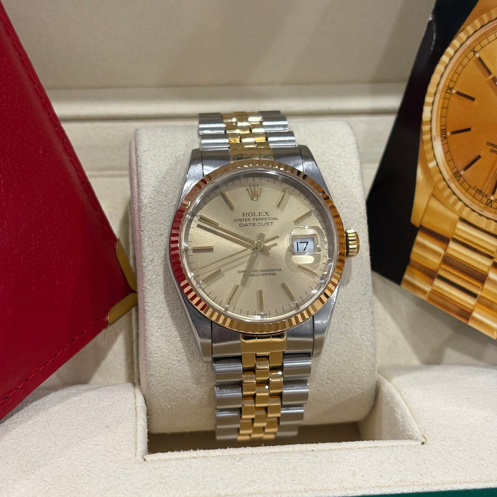 Rolex Datejust 36 two tone champagne index dial close view of the gold stick markers and date Cyclops