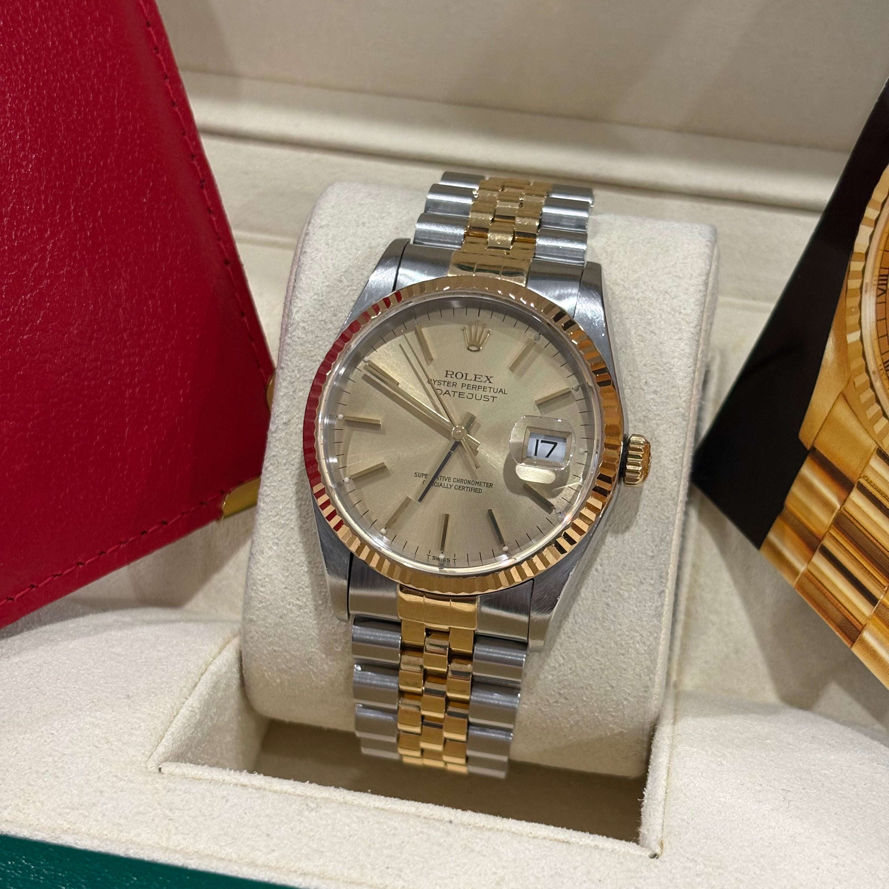 Rolex Datejust 36mm champagne dial angled view showing the yellow gold crown