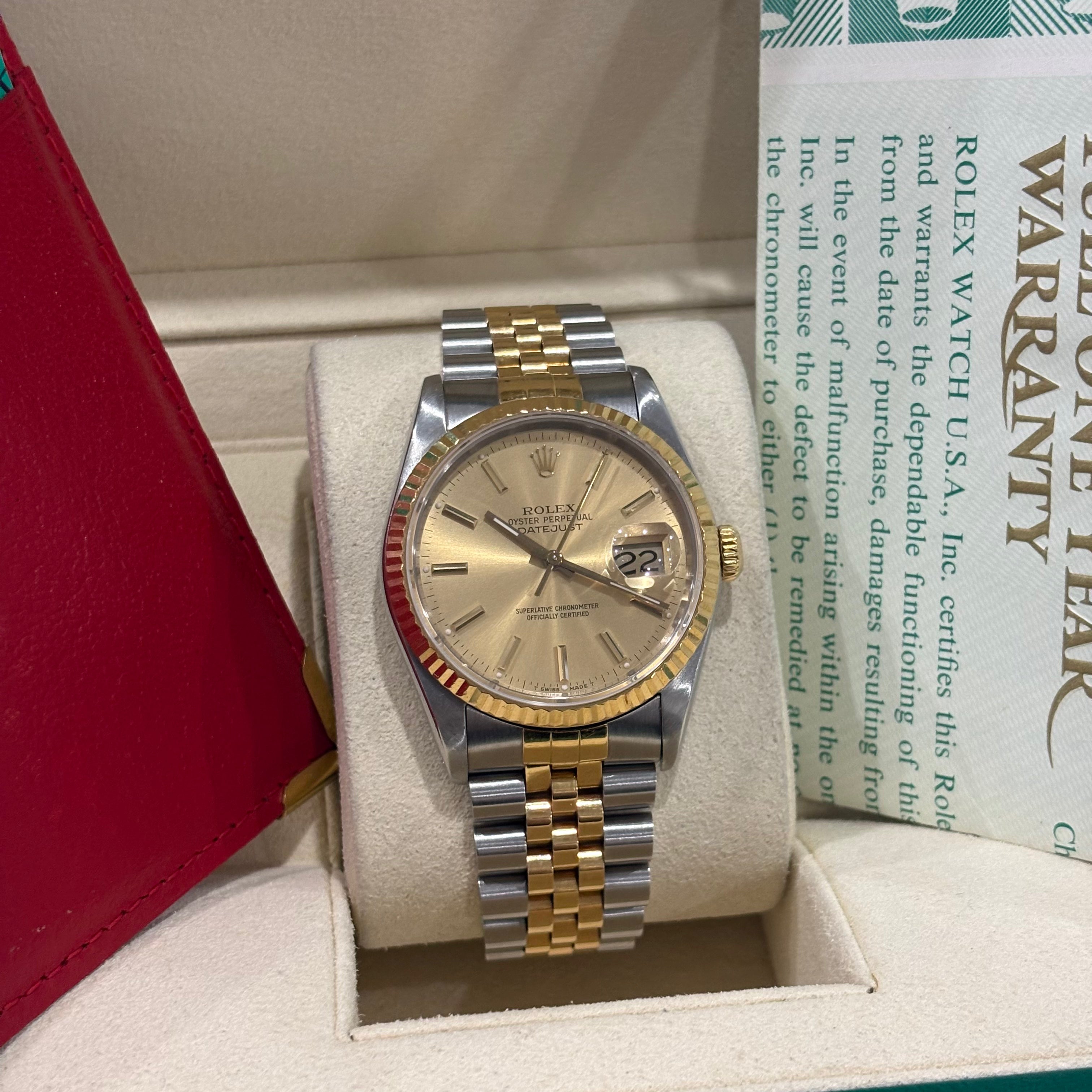 Rolex Datejust 16233 champagne dial front view on its cushion with the fluted yellow gold bezel
