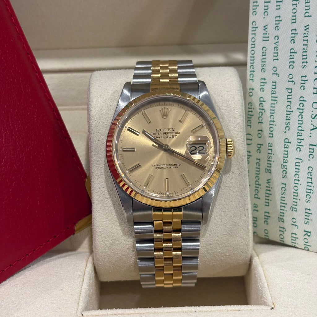 Rolex Datejust 16233 champagne dial angled view showing the yellow gold crown and Jubilee links