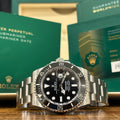 Rolex Submariner Date 41mm ref 126610LN black dial and black Cerachrom bezel with its warranty card at Adonia Jewellers in Yorkville, Toronto