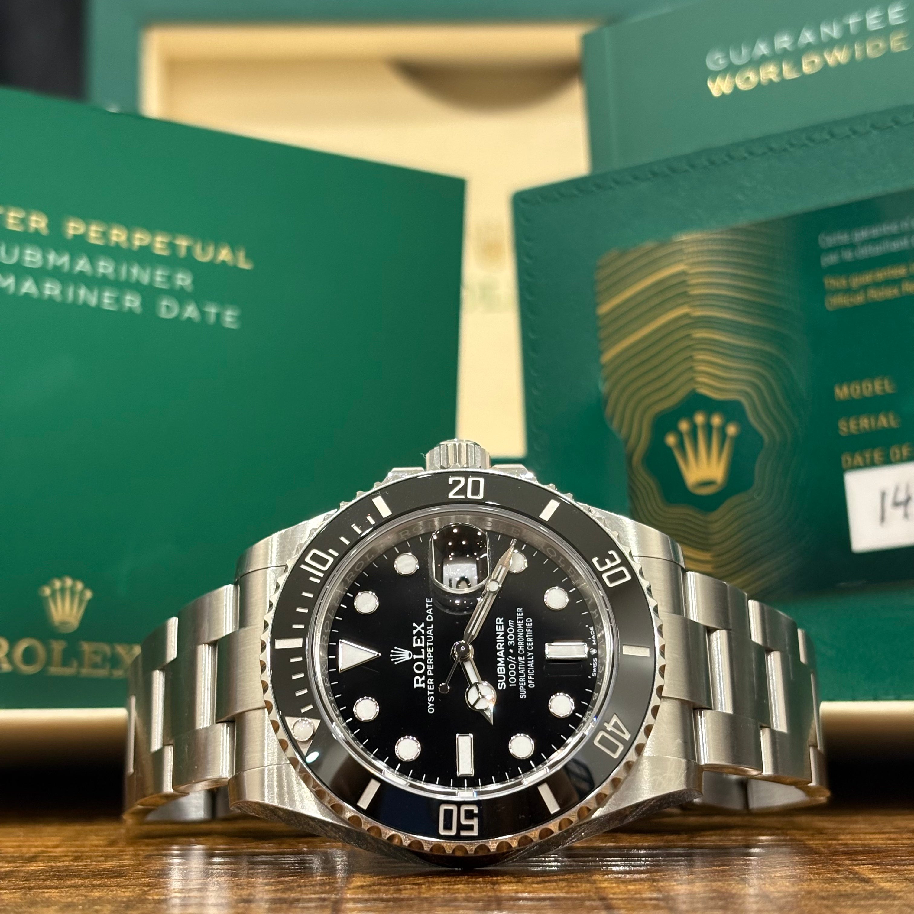 Rolex Submariner Date 41mm ref 126610LN black dial and black Cerachrom bezel with its warranty card at Adonia Jewellers in Yorkville, Toronto