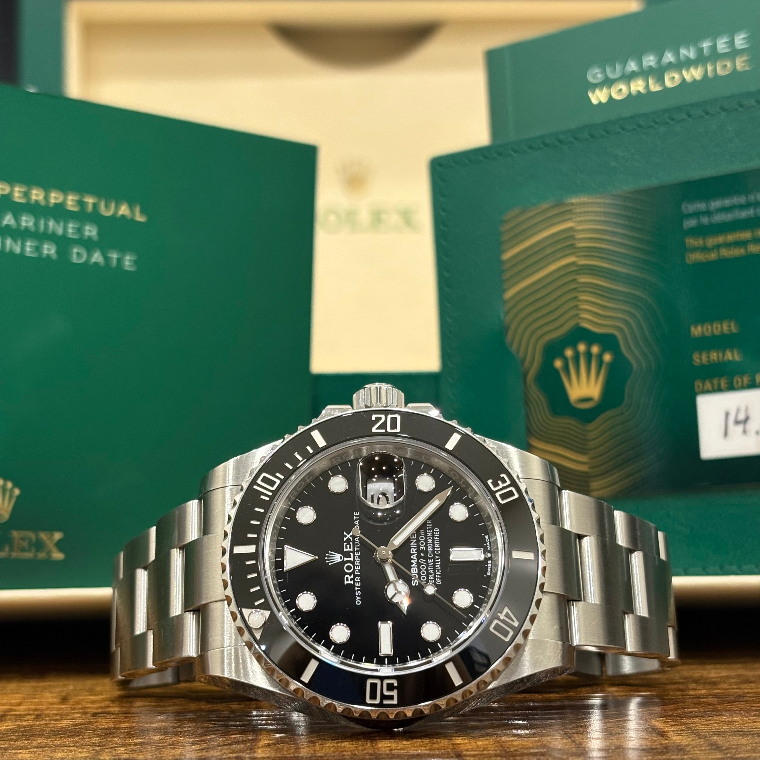 Rolex Submariner Date 126610LN wide view in front of the Submariner booklet and guarantee wallet