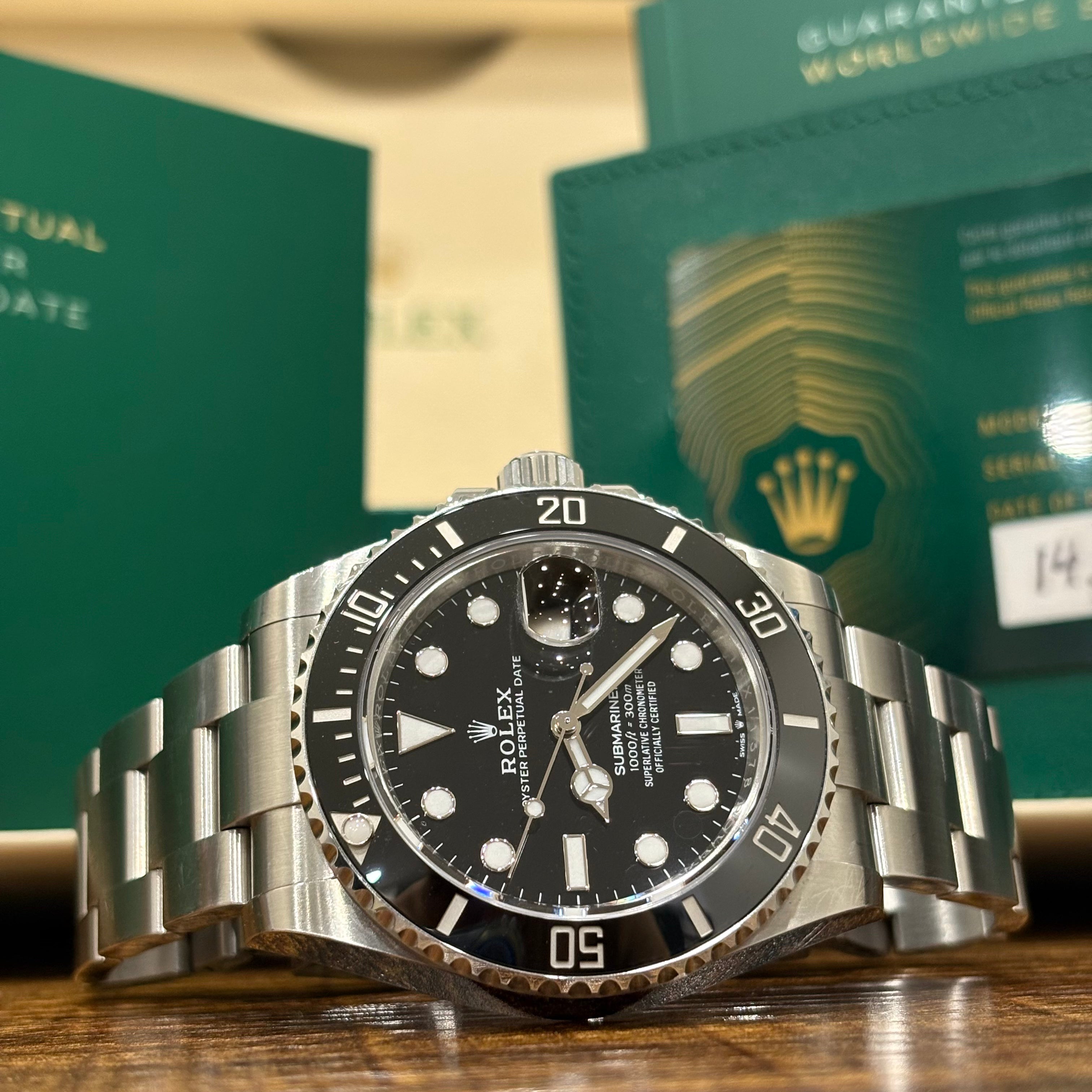 Rolex Submariner Date 41 black dial angled close up of the ceramic dive bezel and crown guard