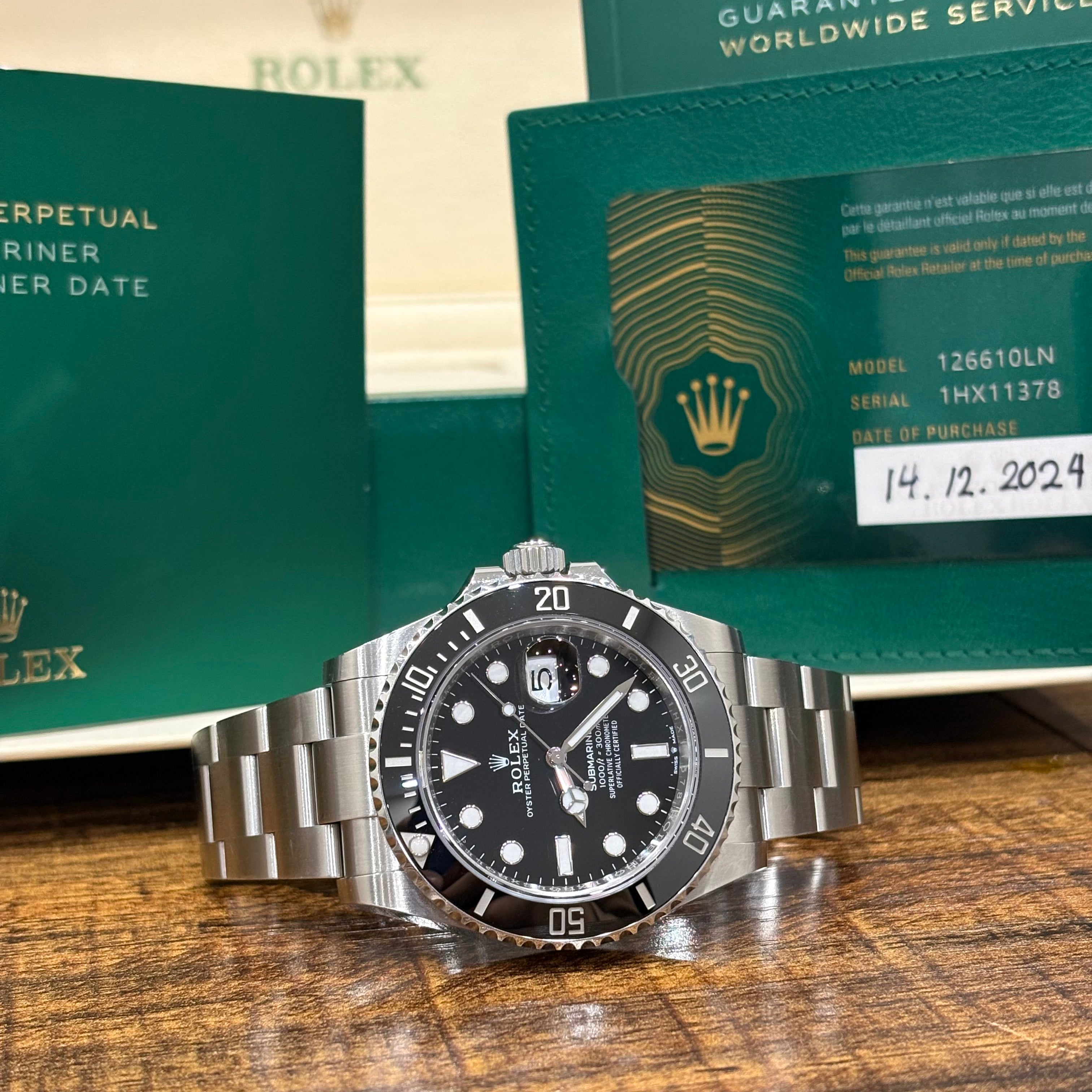 Rolex Submariner Date 126610LN with its 2024 dated warranty card showing the model number