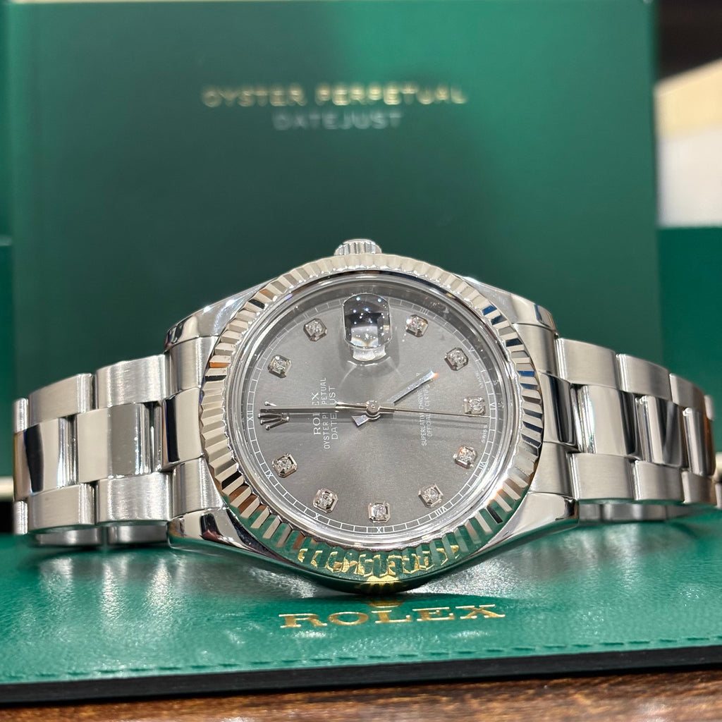 Rolex Datejust 41 slate diamond dial side on view in front of the Datejust booklet